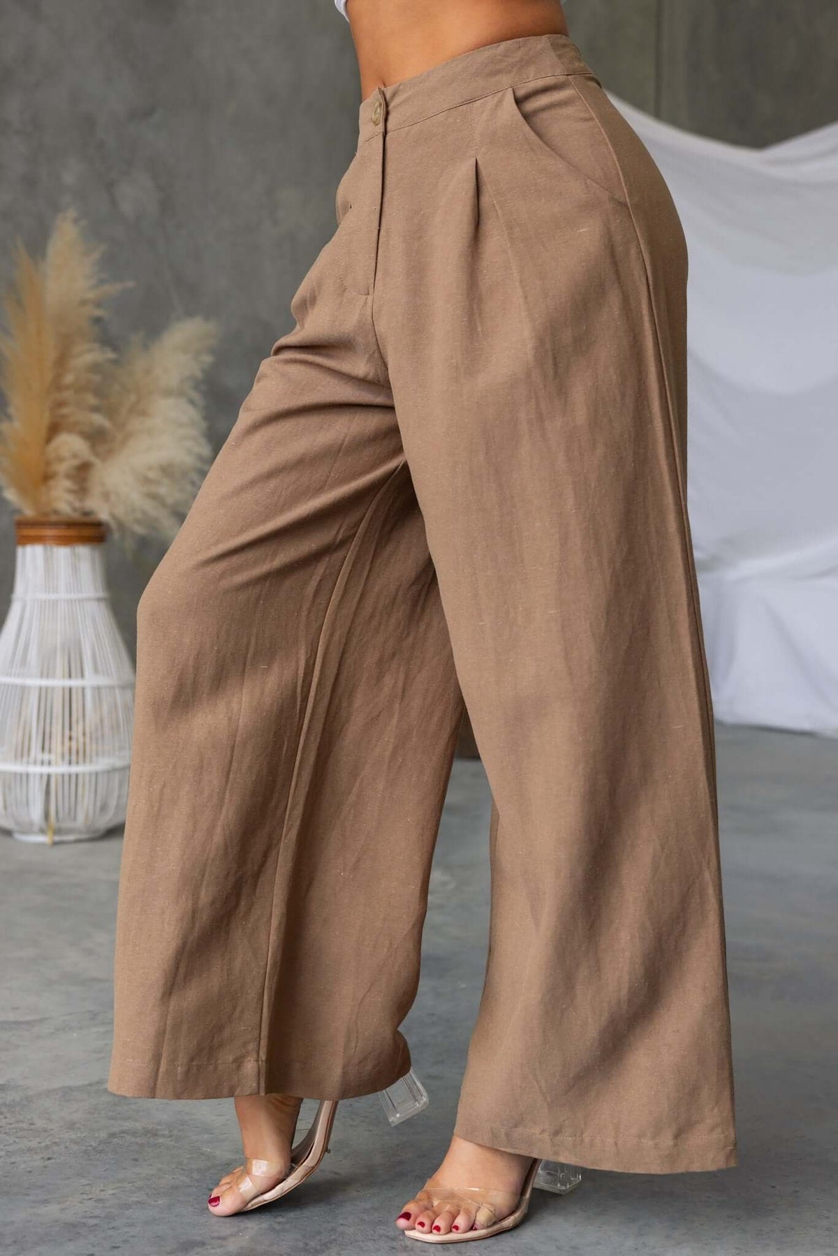 Carter's pants featuring a mid-high waist fit, linen feel, and pockets, styled casually with a neutral backdrop.