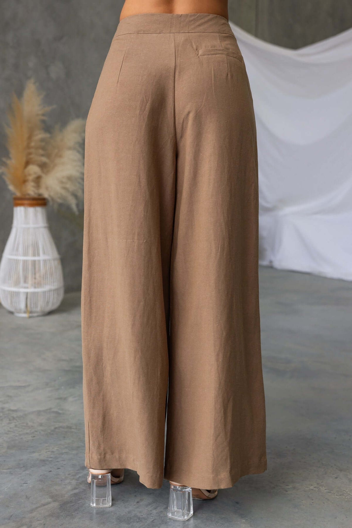 Back view of Carters pants in light brown linen, featuring a mid-high waist fit and wide leg design.