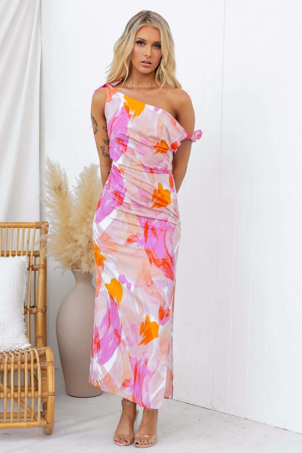 Model wearing Annerly Maxi Dress with one-shoulder neckline and tie straps, featuring floral print and side split.