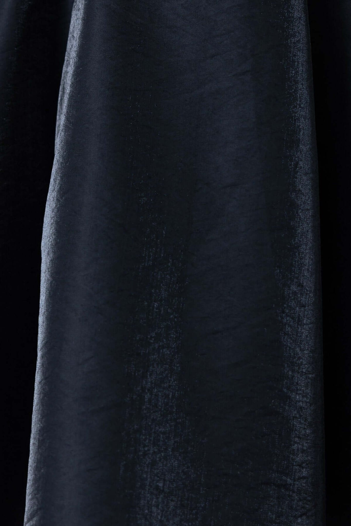 Close-up of the satin fabric of the Sandy Dress, showcasing its smooth texture and rich color.