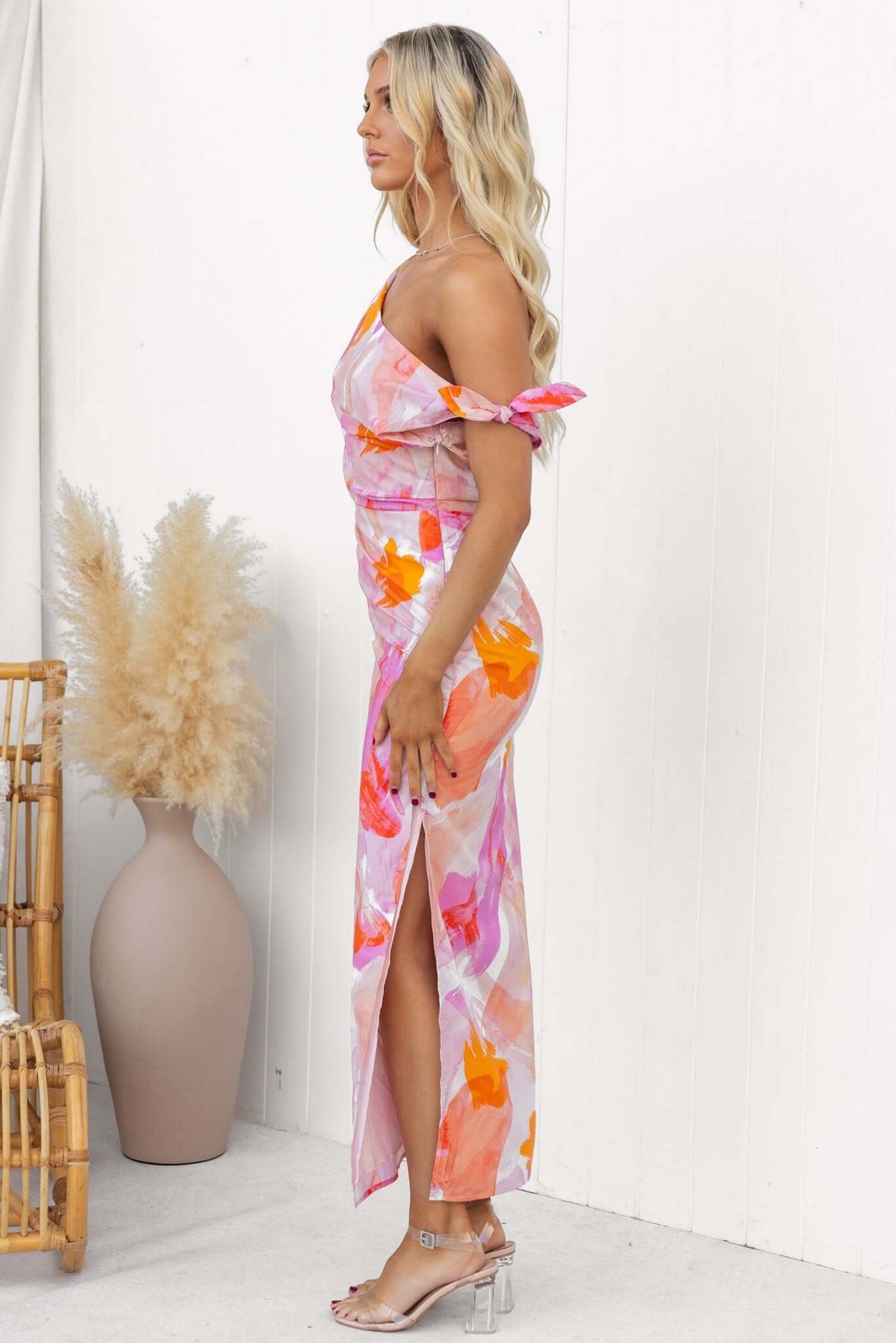 Annerly Maxi Dress with one-shoulder neckline and side split, styled in vibrant pink and orange floral print.