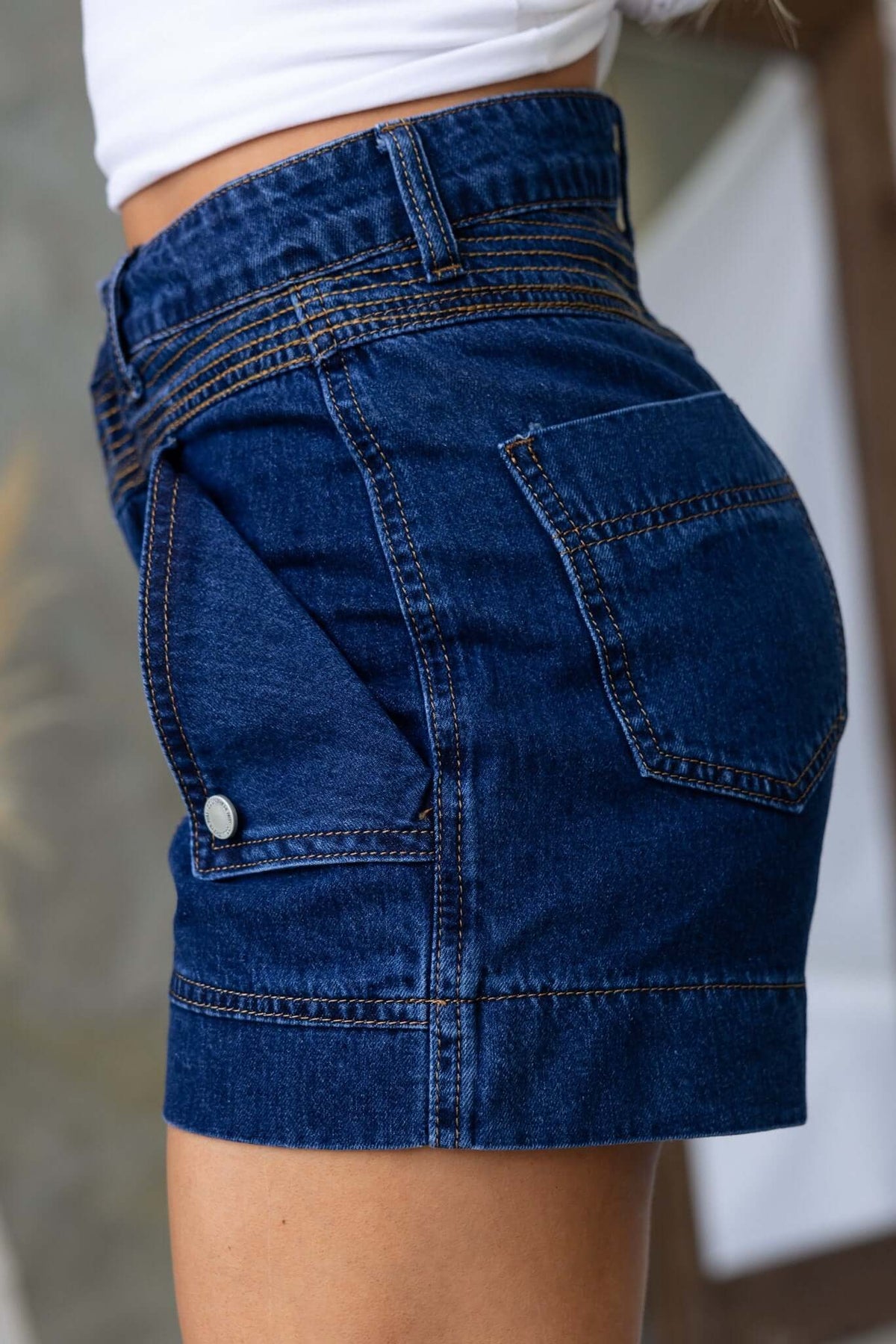 Side view of Kodiak denim shorts showcasing button closure, two pockets, and a standard fit.