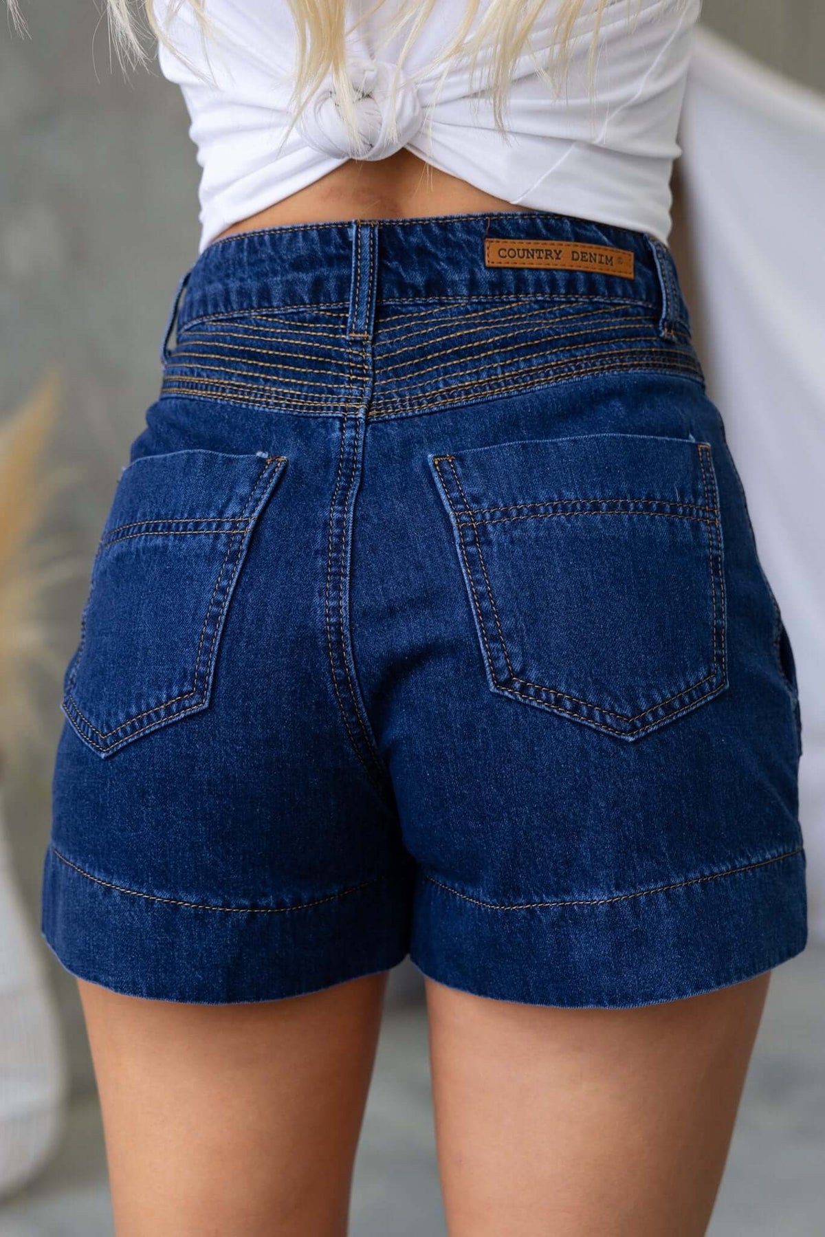 Back view of Kodiak Shorts showcasing denim design, button detailing, and fixed pockets for a stylish casual look.
