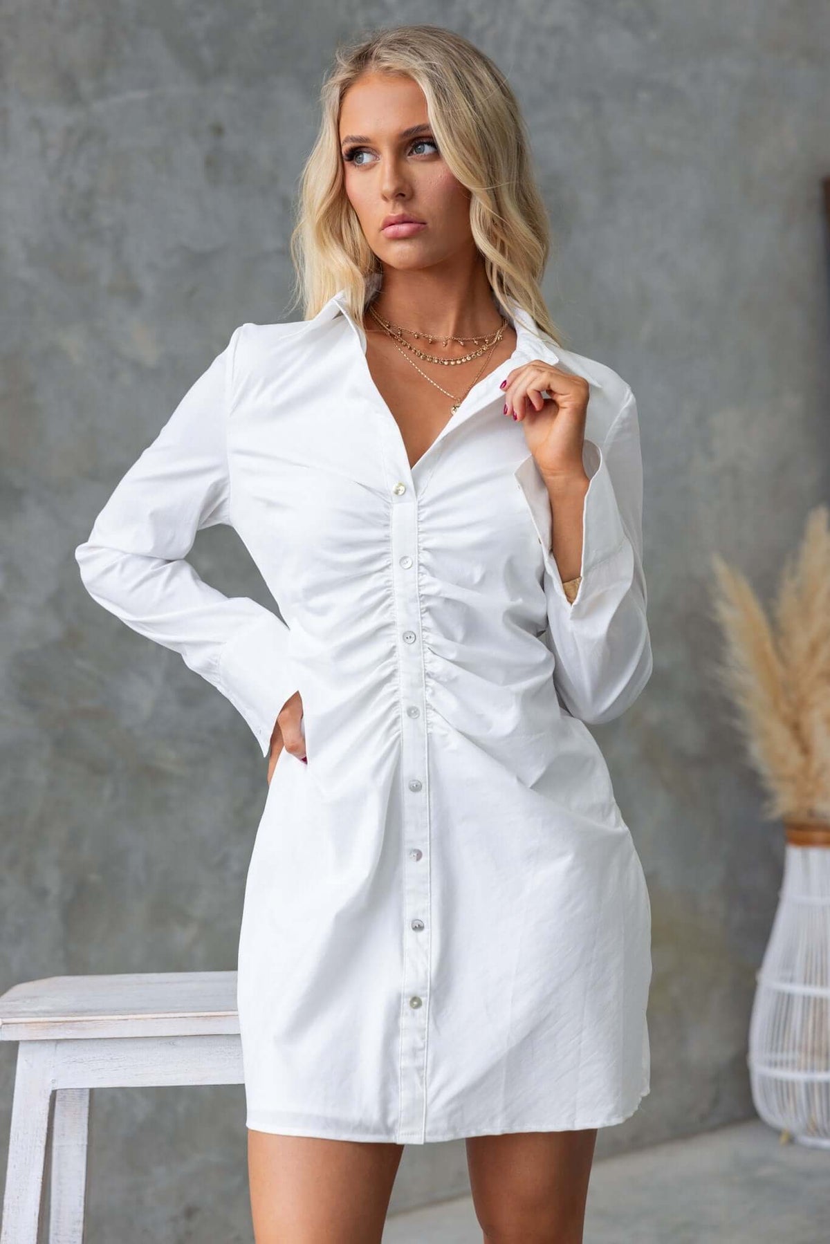 Model wearing a white Markie Dress with faux button front and ruching detail, perfect for stylish casual wear.