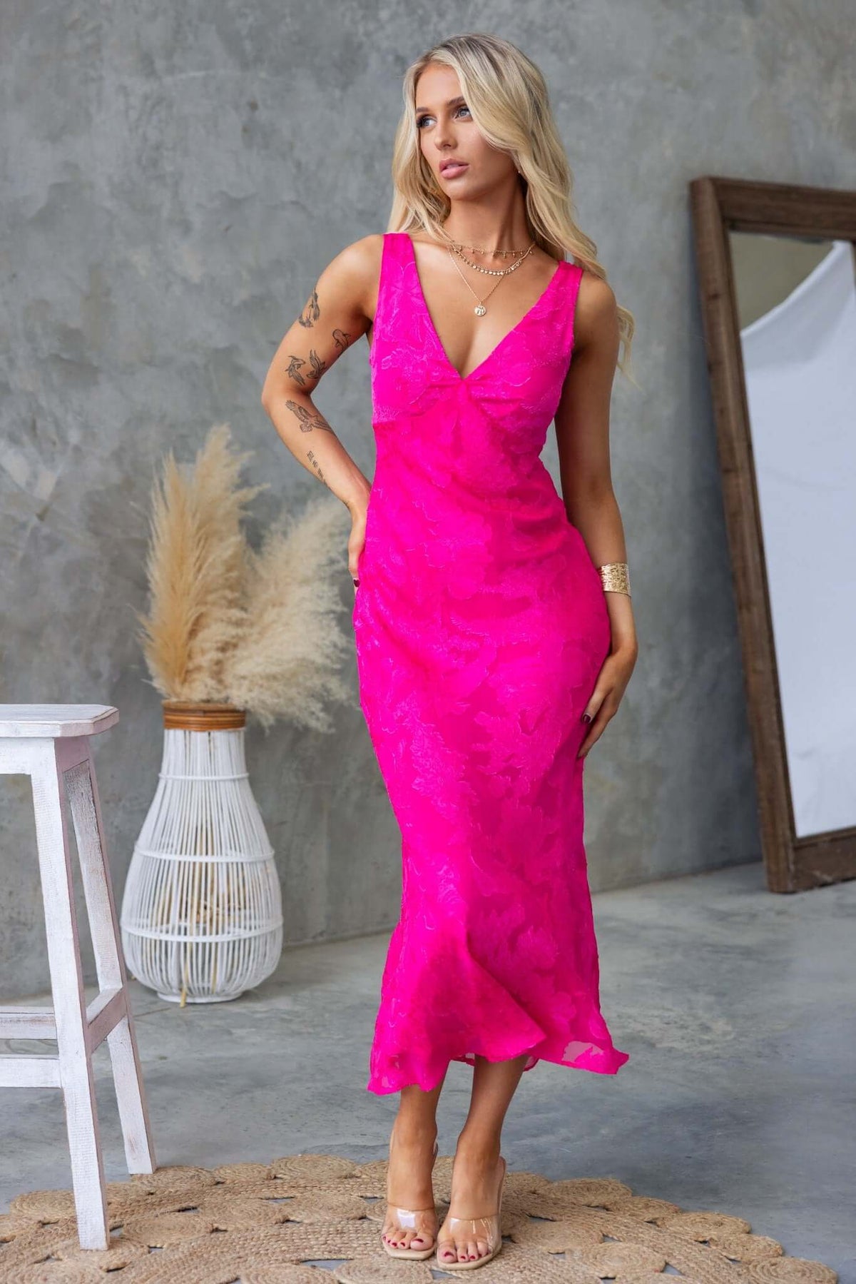 Qilax Maxi Dress in vibrant pink with a textured flower print, featuring a stylish neckline and sleek fit.