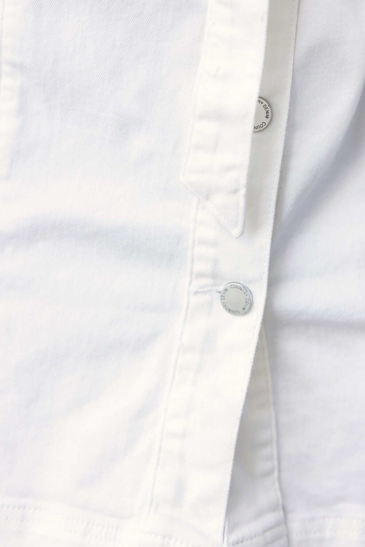 Close-up of white denim dress featuring button details for the Forever Me Denim Dress.