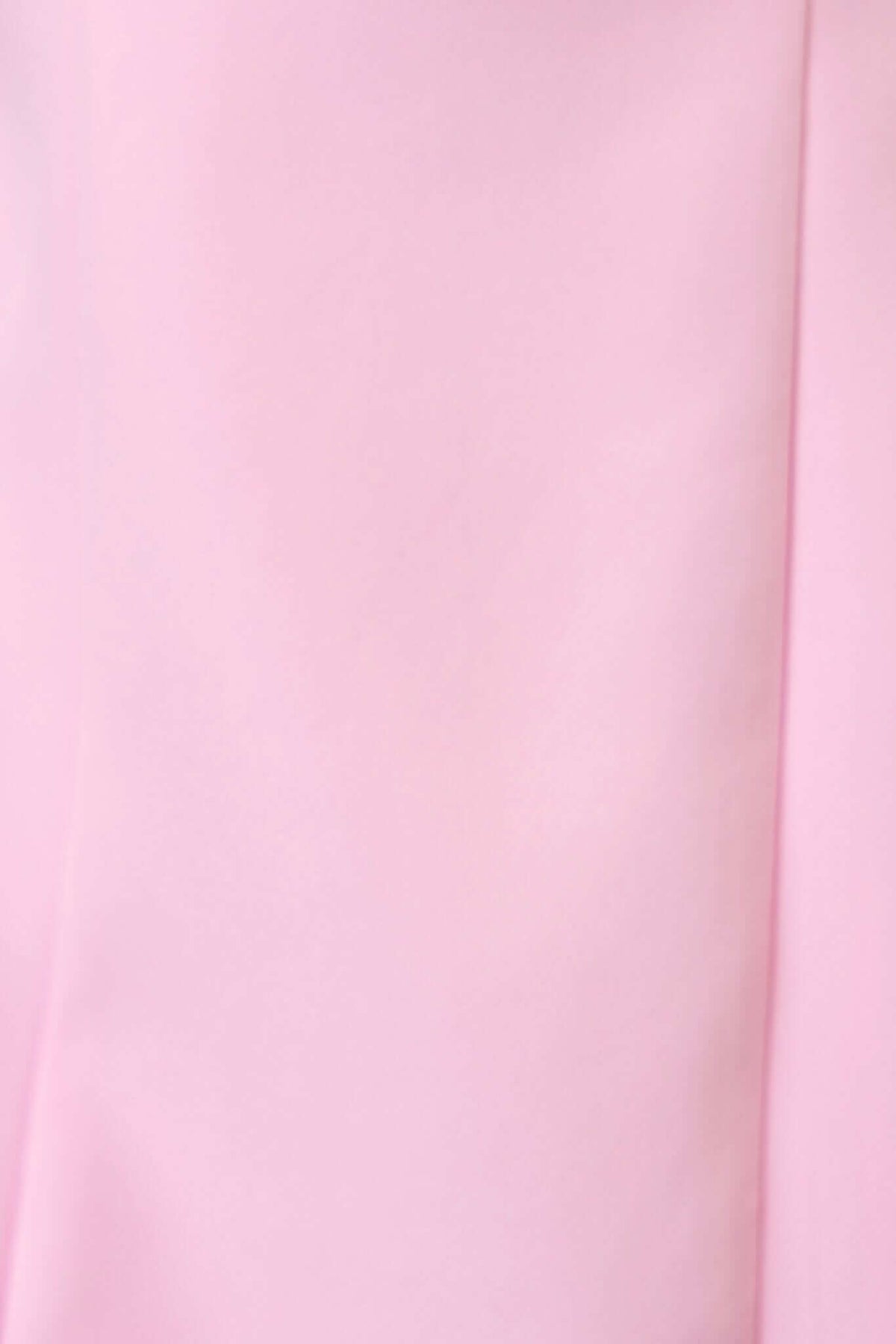 Close-up of a soft pink fabric showcasing smooth texture, ideal for the Demure Dress.