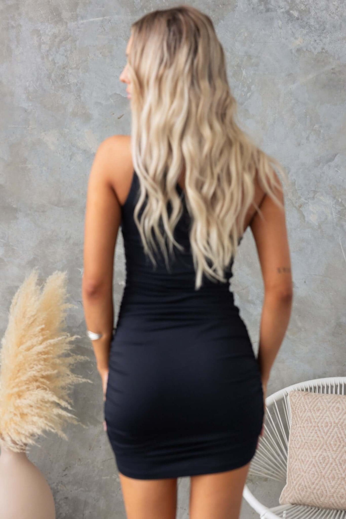 Women's Martinez dress featuring a one-shoulder design, silver buckle, and a fitted silhouette in black.
