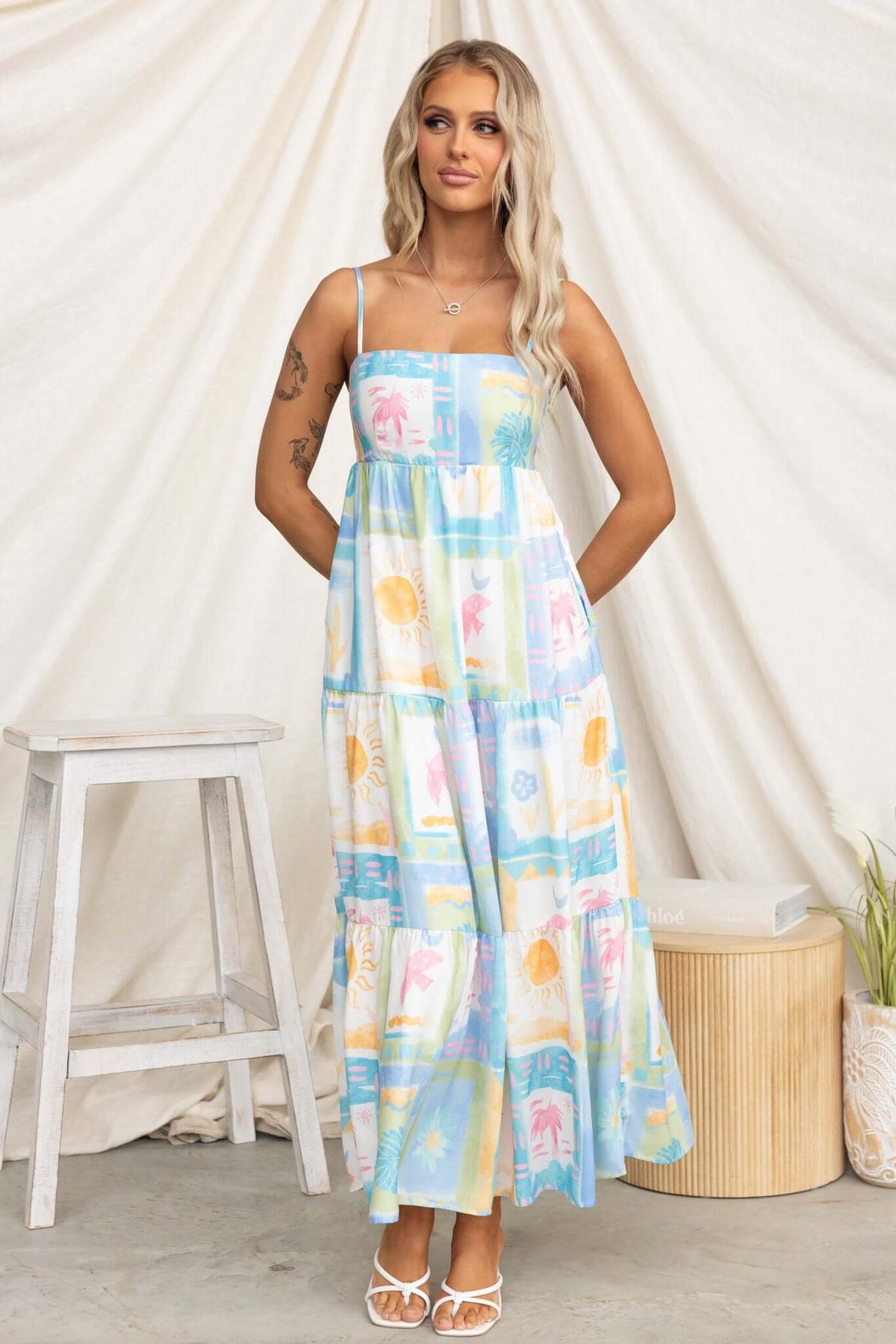 Waterloo Maxi Dress featuring adjustable straps, pockets, and a colorful print, perfect for summer outings.