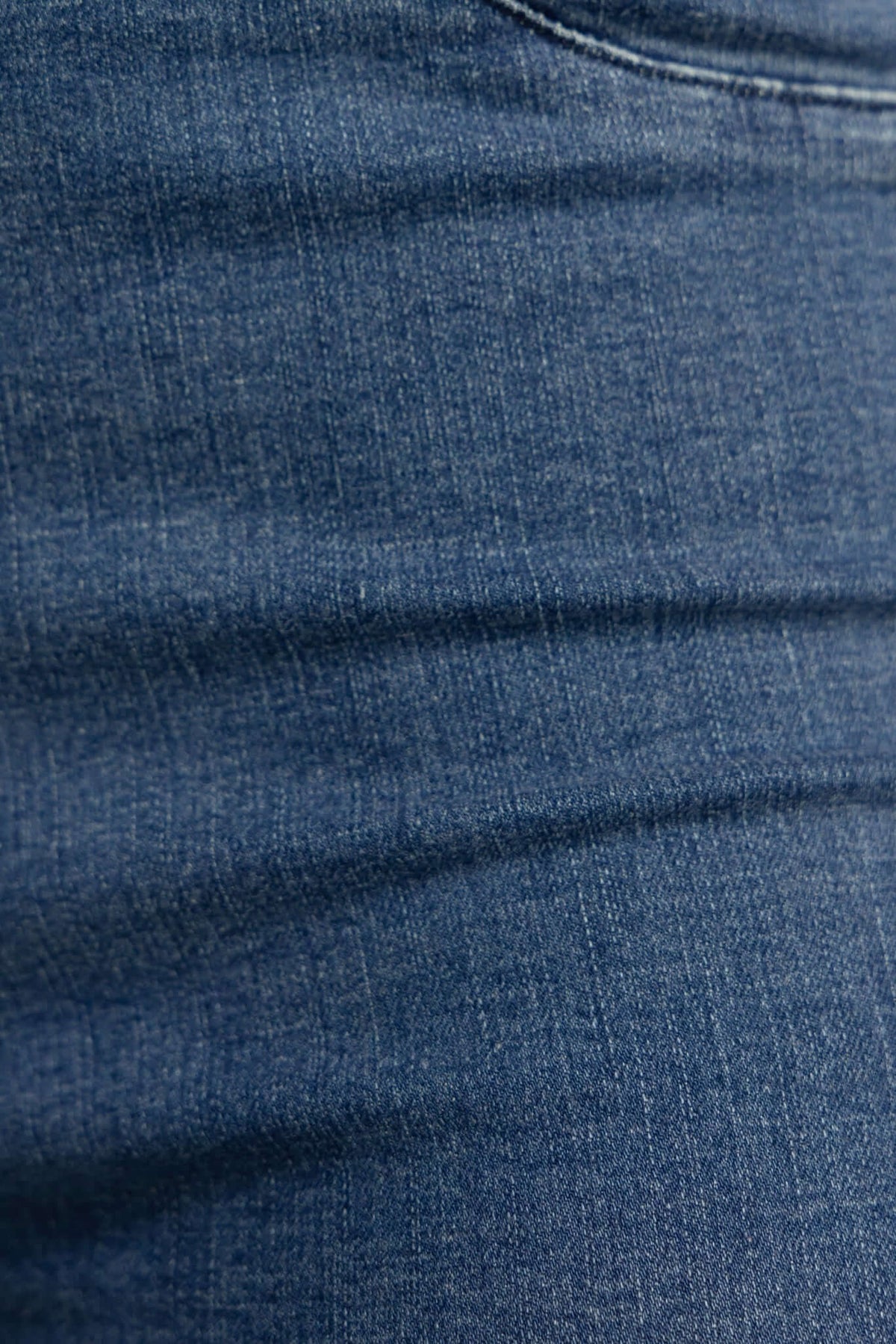 Close-up of textured denim fabric showcasing the deep blue color and stretch quality of Durant Jeans.