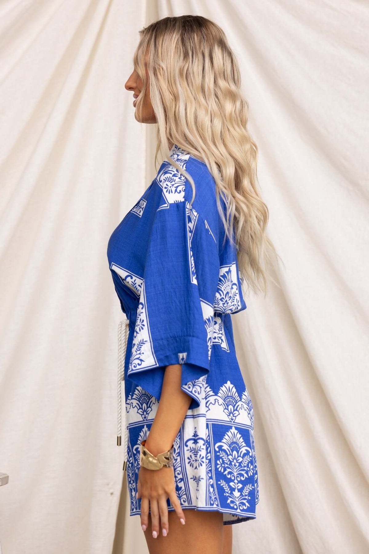 Model wearing a blue Fiddler Playsuit featuring a collar, button-up front, and relaxed fit.