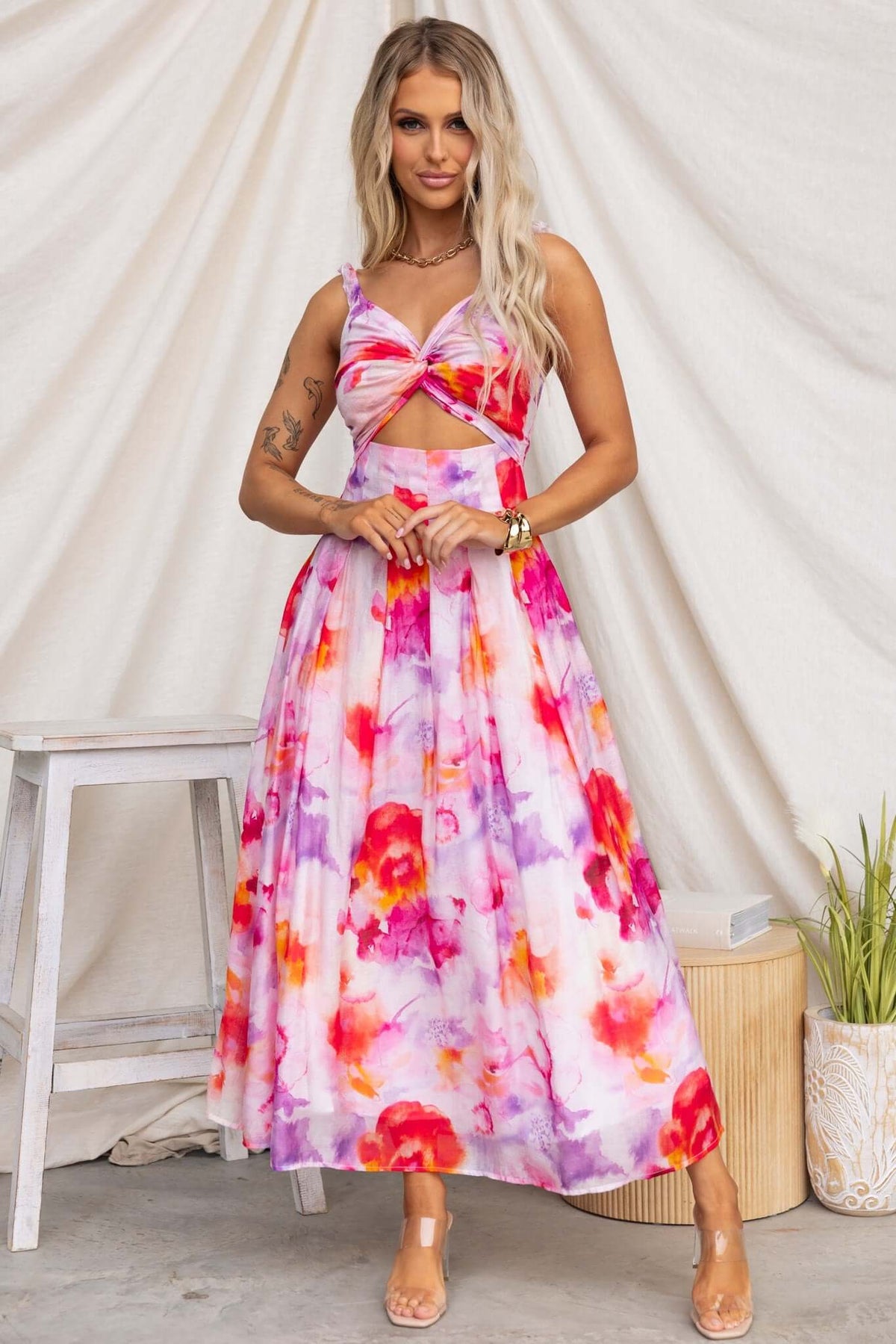 Estelle Midi Dress featuring elastic straps, cut-out waist, floral print, and flattering silhouette.