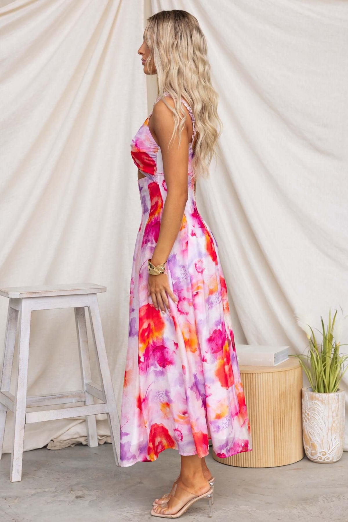 Side view of Estelle Midi Dress featuring a colorful floral pattern and elastic straps, perfect for warm-weather occasions.