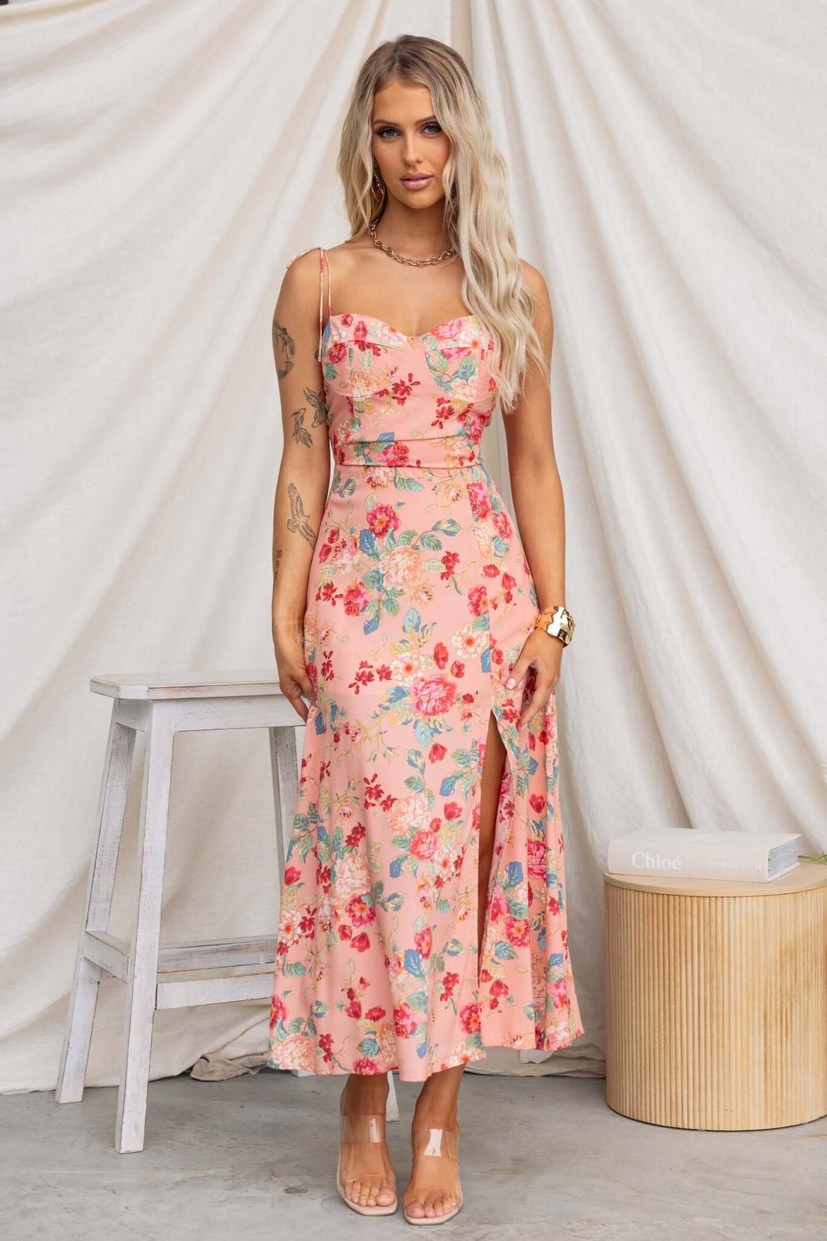 Briony Maxi Dress with floral pattern, adjustable spaghetti straps, and front split, styled elegantly for summer wear.