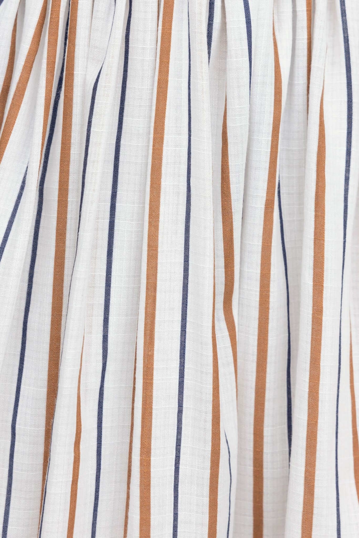 Close-up of Elkie Midi Dress with vertical stripes in white, navy, and rust colors, showcasing the fabric's texture.