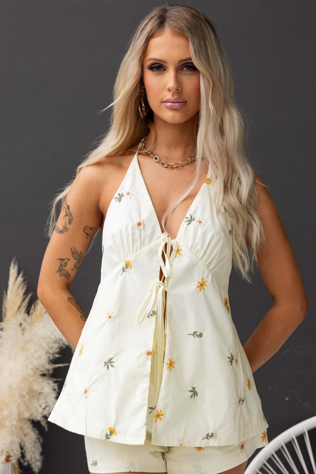 Tori Top featuring tie neckline with floral design, perfect for warm weather, made of 100% cotton with a relaxed fit.