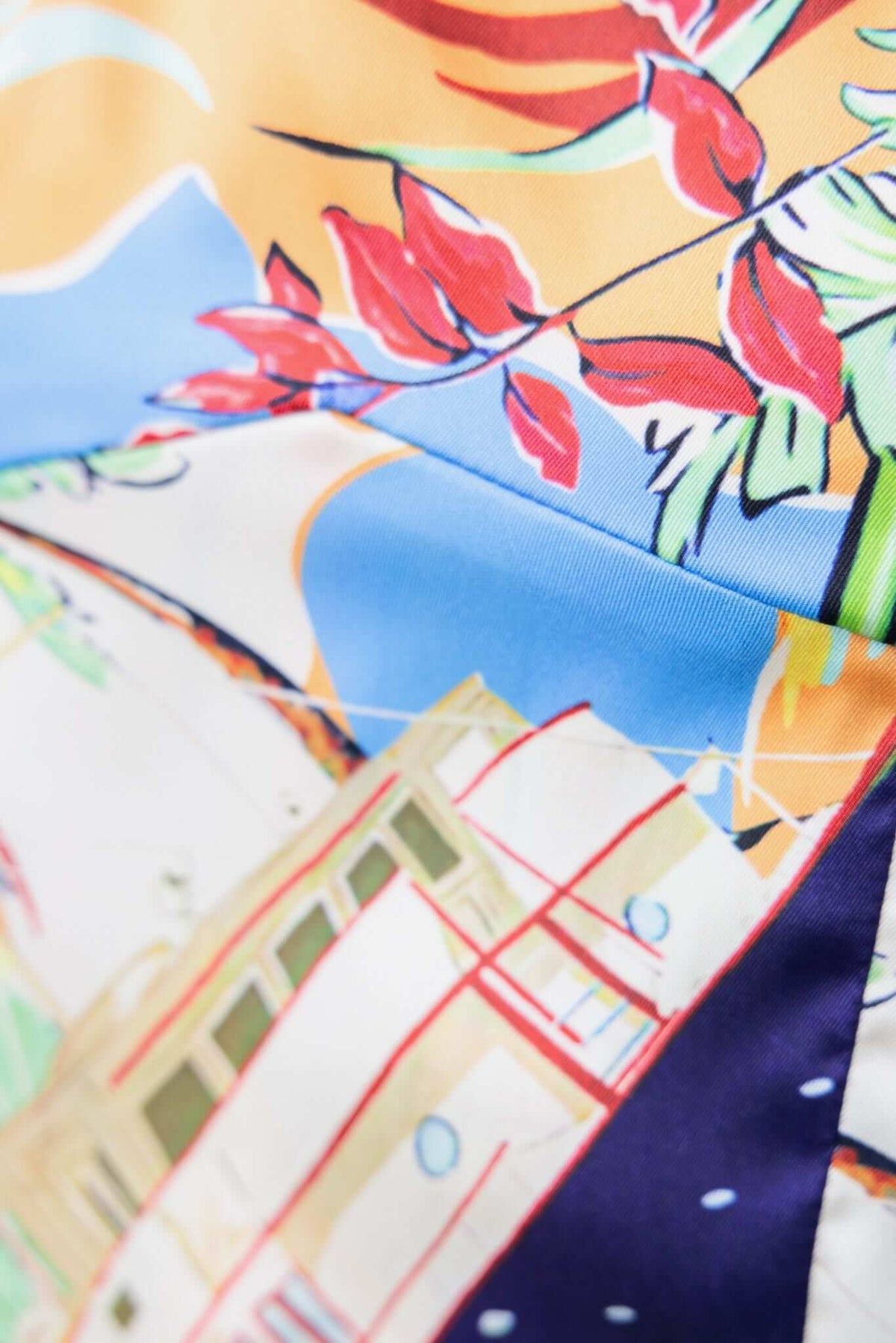 Close-up of vibrant floral pattern on Saluzzo Pants, showcasing intricate design details and colors.