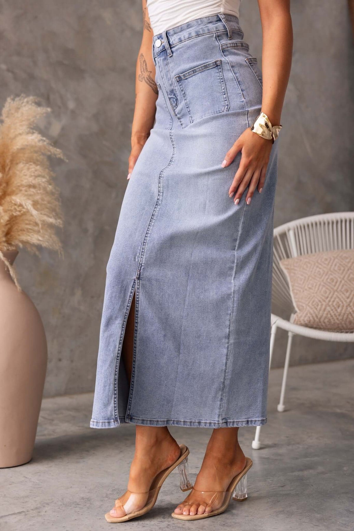 Model wearing a Naomi Denim Maxi Skirt with a front split and pockets, showcasing mid-high waist style.