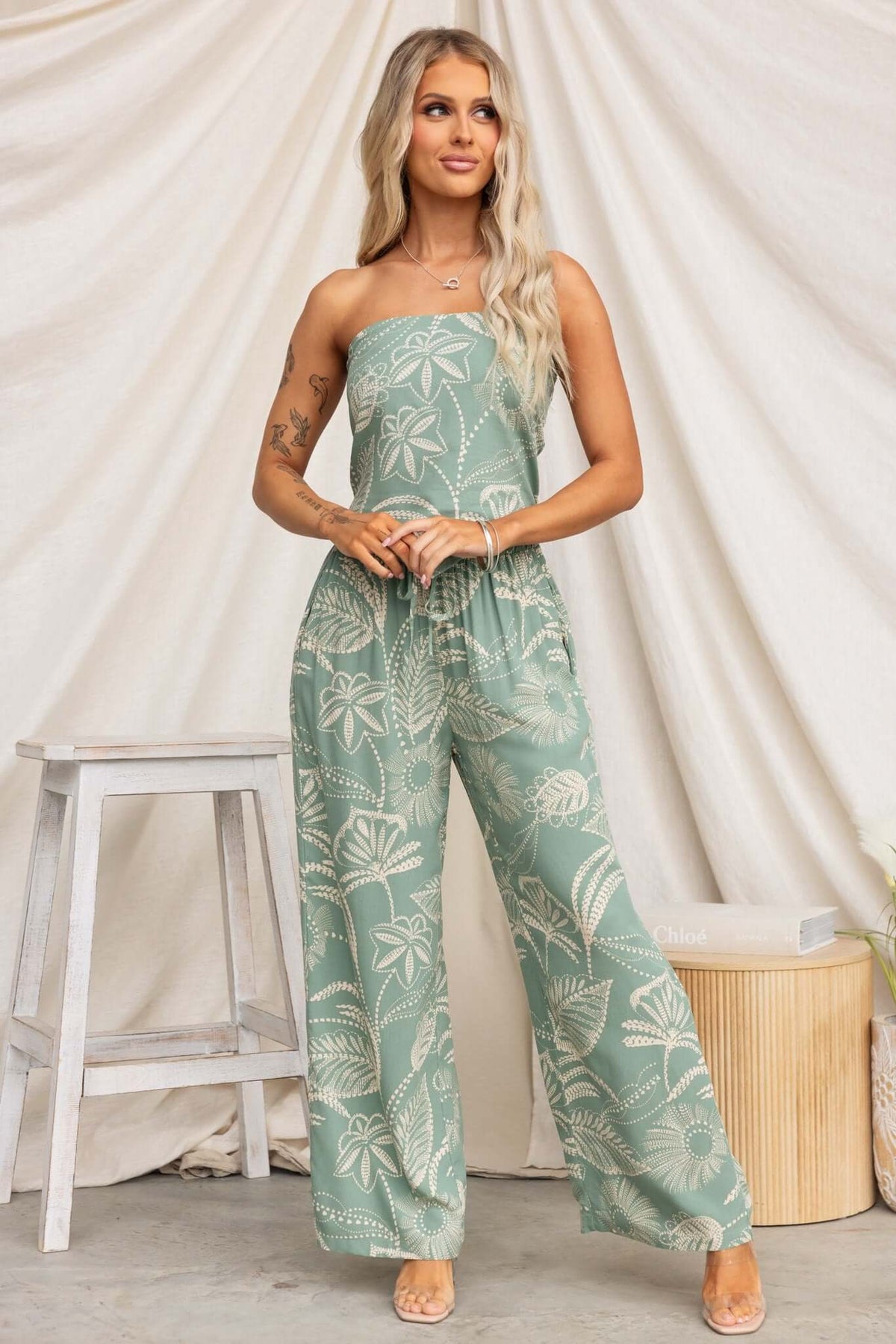 Model wearing a strapless Lasan set with floral print, featuring non-stretch pants and an elastic waistband.