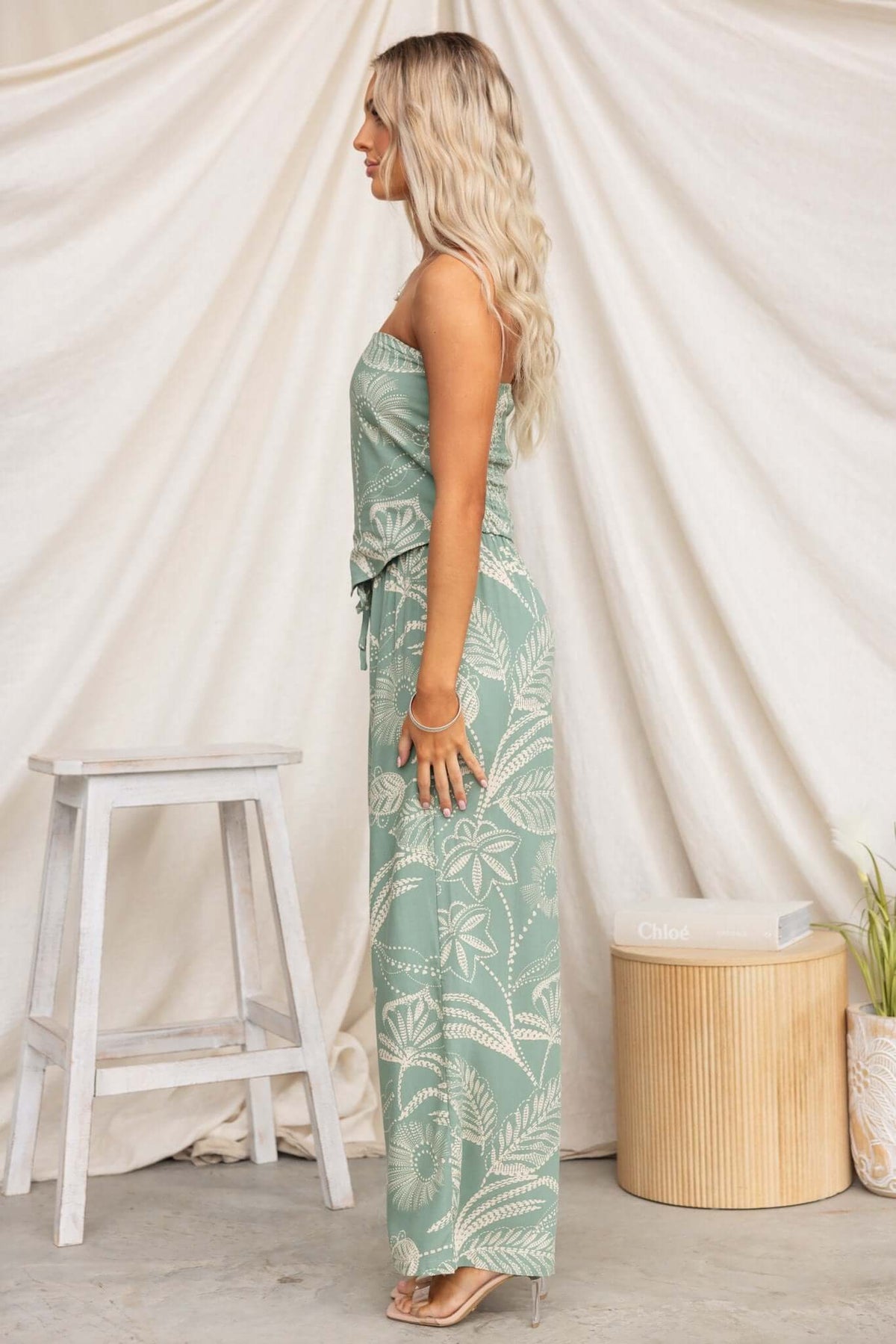 Model in a strapless Lasan Set featuring a palm print design, mid-high waist non-stretch pants, and elastic waistband.