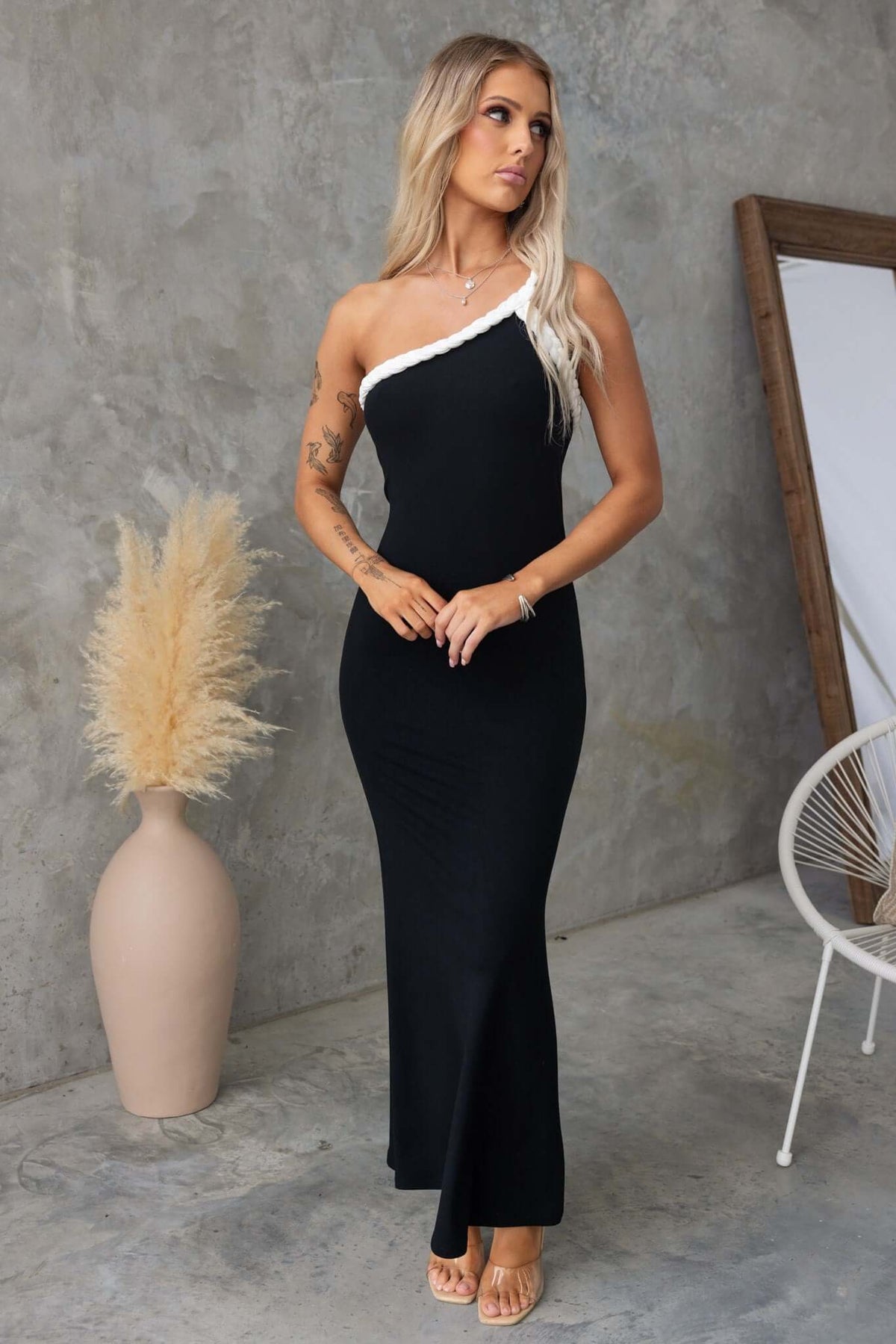 Stylish Sabyna Maxi Dress with one-shoulder neckline in black, showcased on model against a minimalist backdrop.