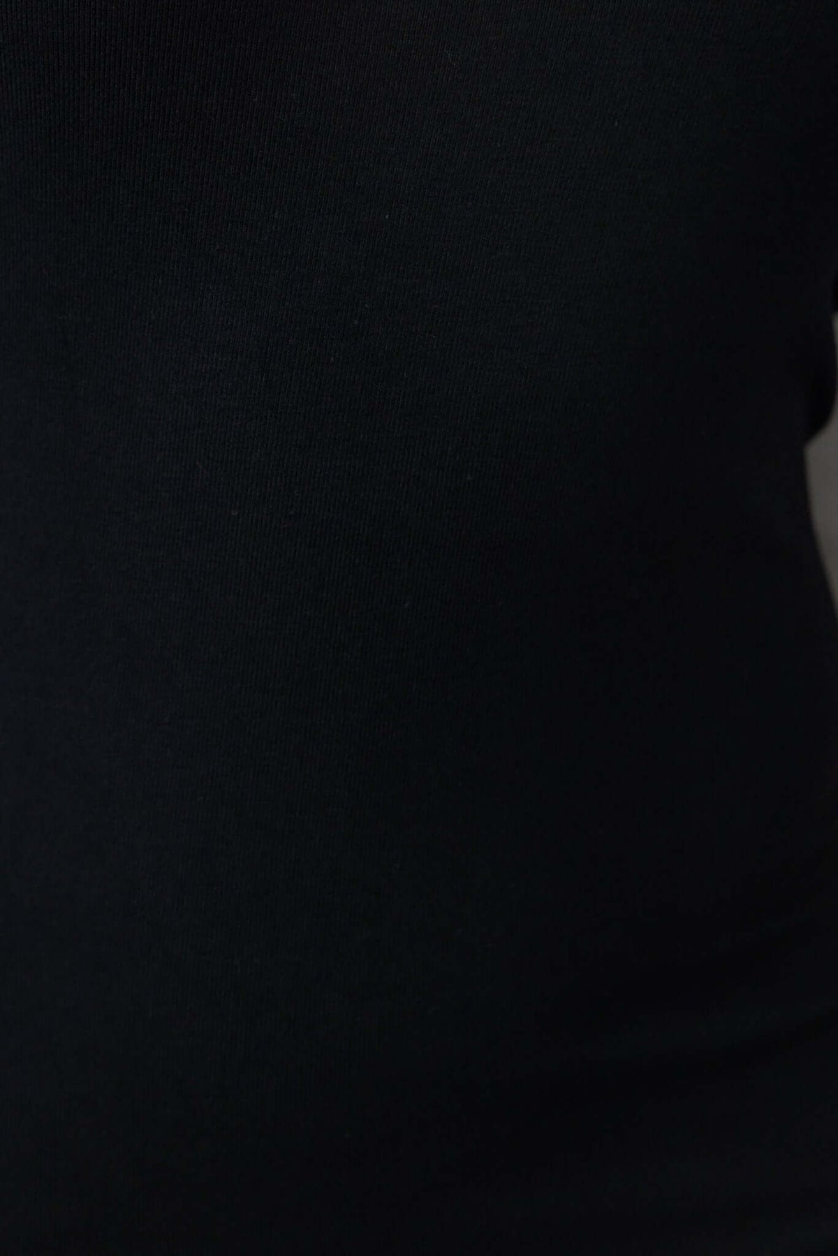 Close-up of the black lightly ribbed fabric of the Sabyna Maxi Dress, showcasing its stretchy material.