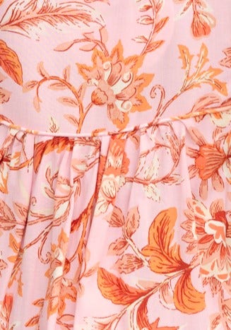 Close-up of floral print in pink hues featuring flowers and leaves, showcasing fabric details of Reeva Top.