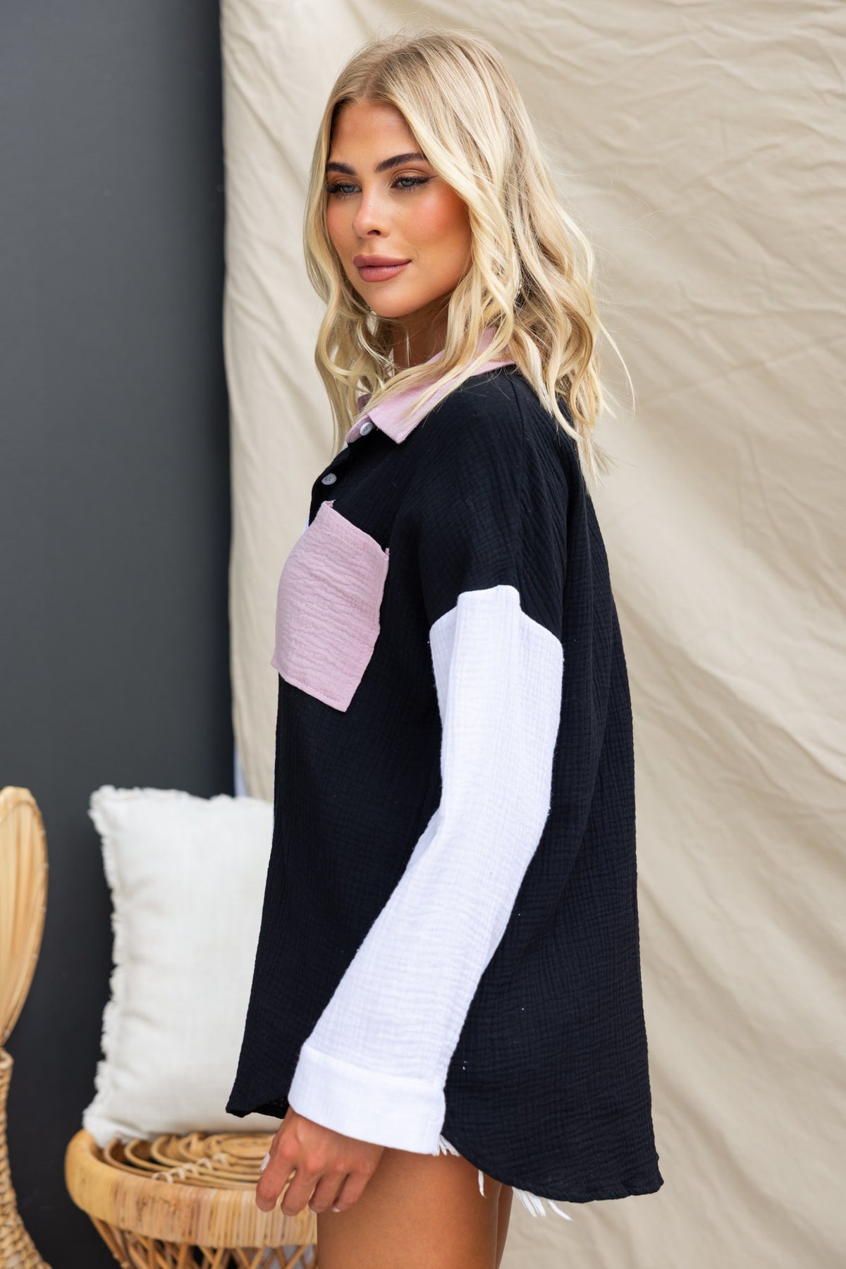 Atticus Top in black cotton with pink collar, button-up front, and pocket, styled in oversized fit.
