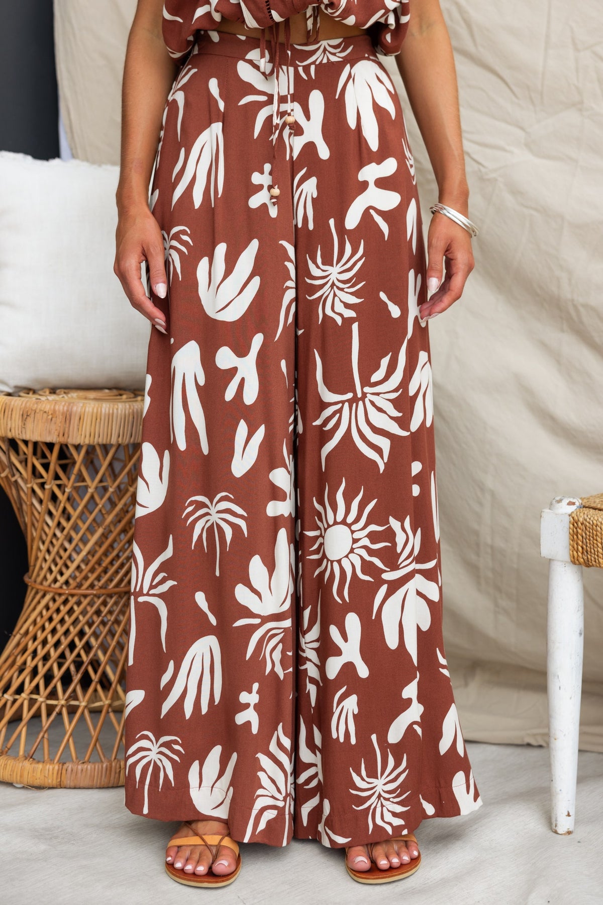 Ethan Pants featuring abstract print, mid-high waist, and pockets on a model in a stylish setting.