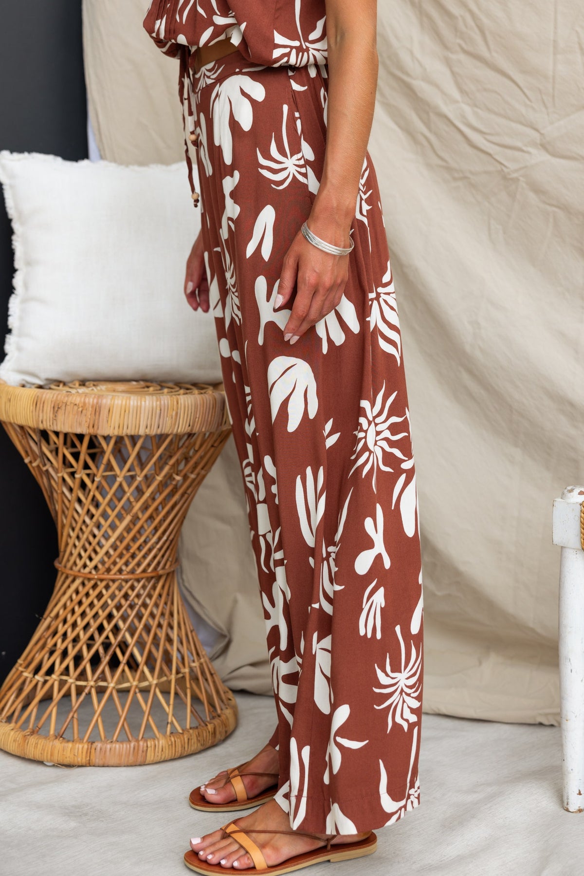 Ethan Pants featuring a mid-high waist fit, elastic waistband, and abstract print design, paired with sandals.