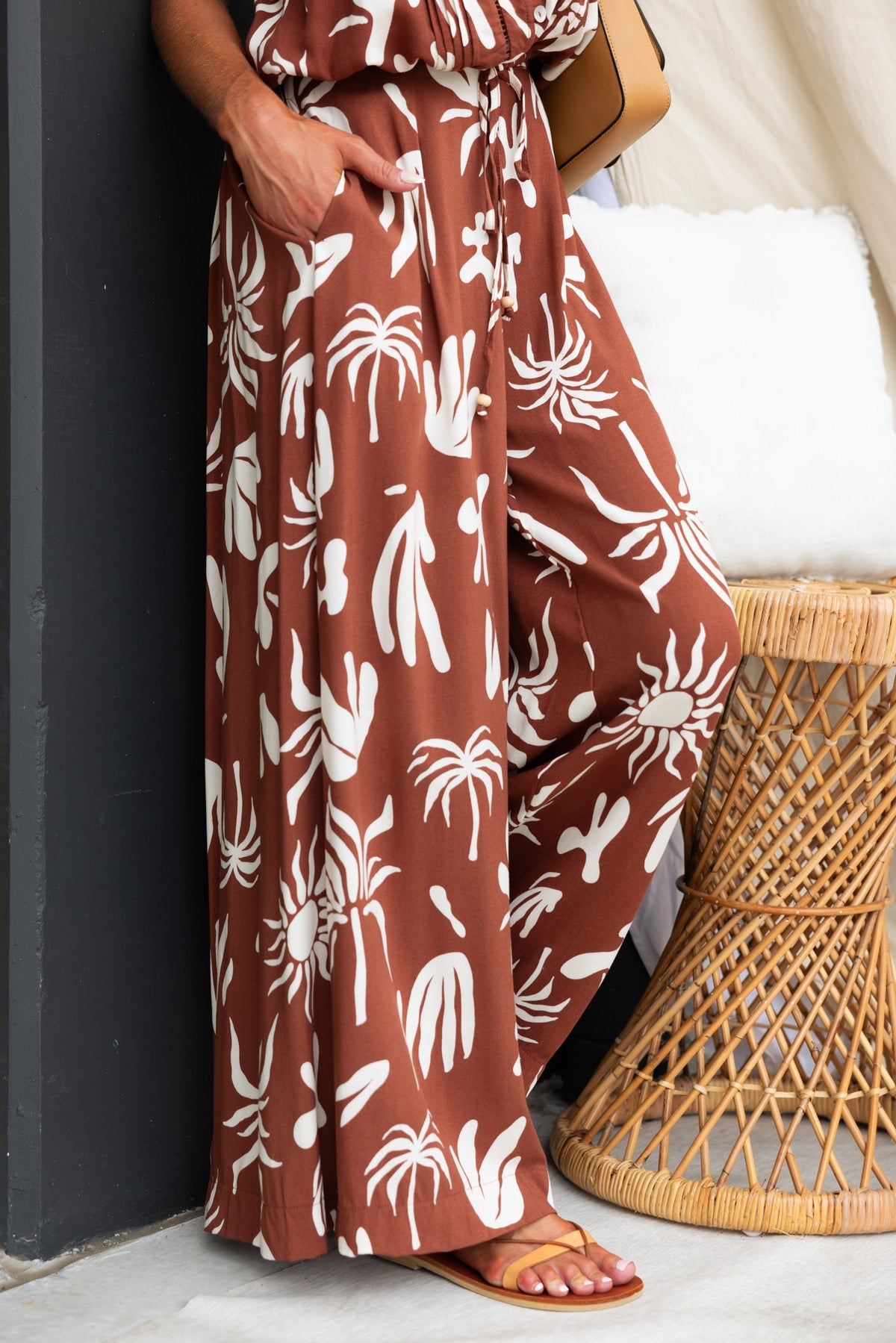 Ethan Pants in abstract print with mid-high waist, pockets, and light material, styled with sandals.