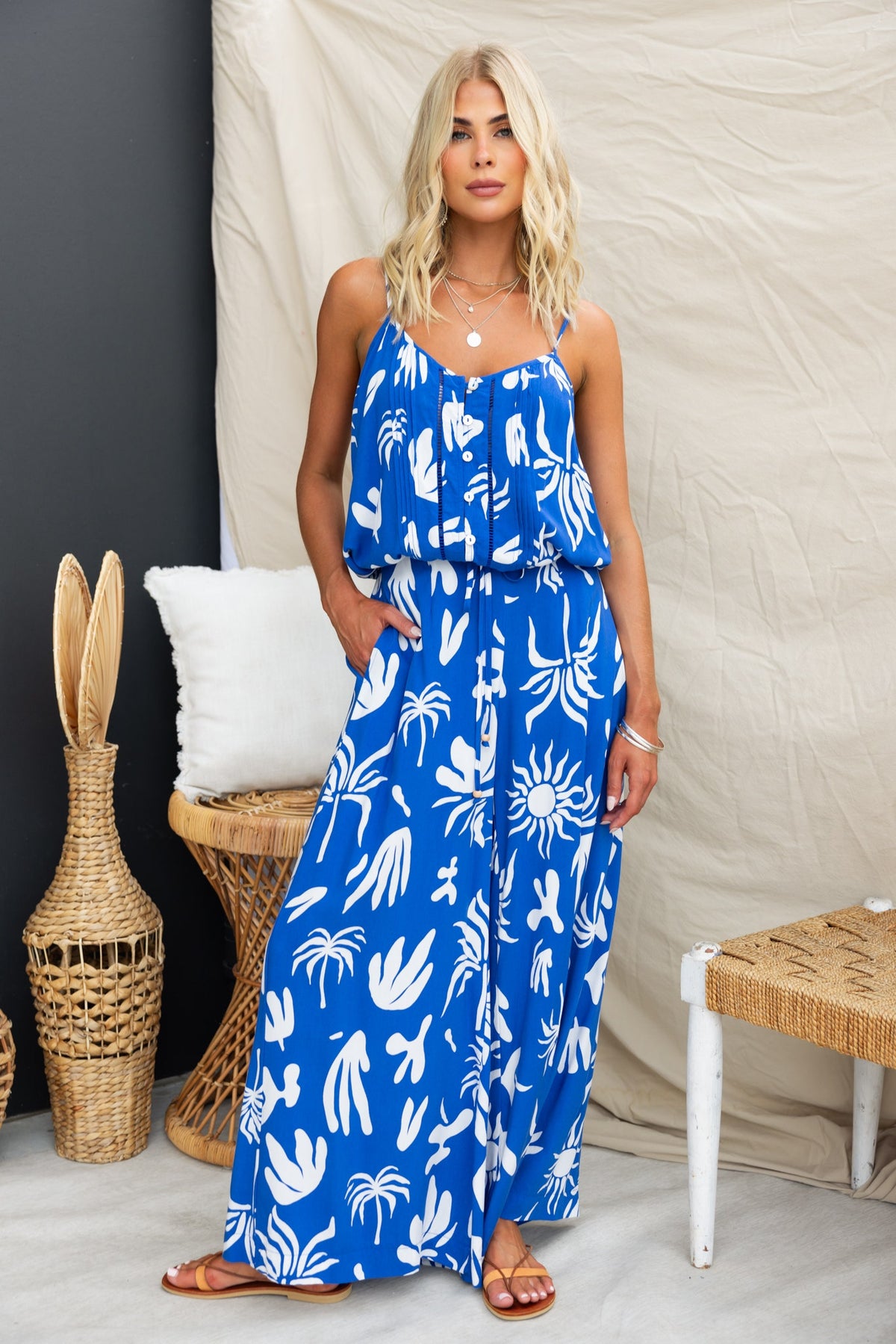 Model wearing a blue abstract print maxi dress, showcasing a relaxed fit and stylish design, set against a neutral background.