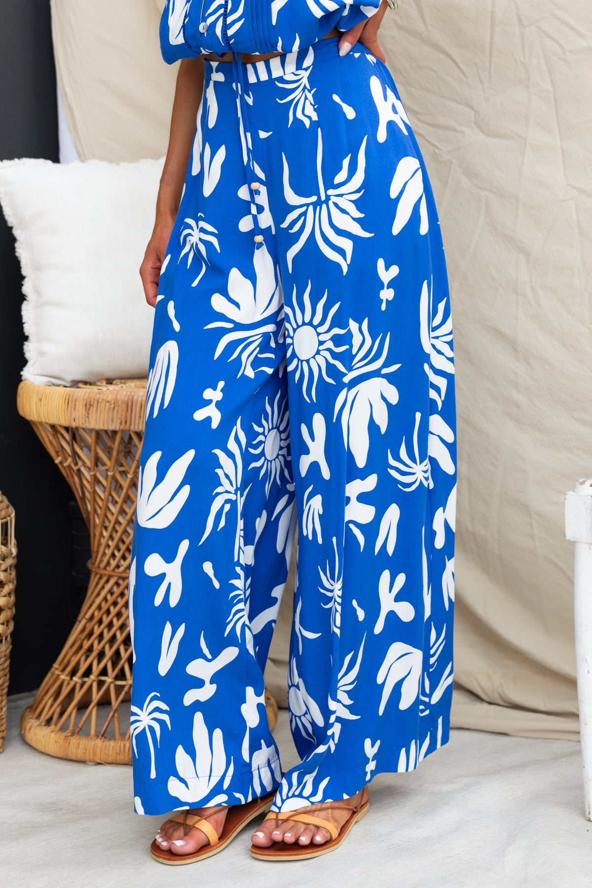 Ethan Pants in vibrant blue with abstract white print, featuring a mid-high waist and pockets for a relaxed fit.