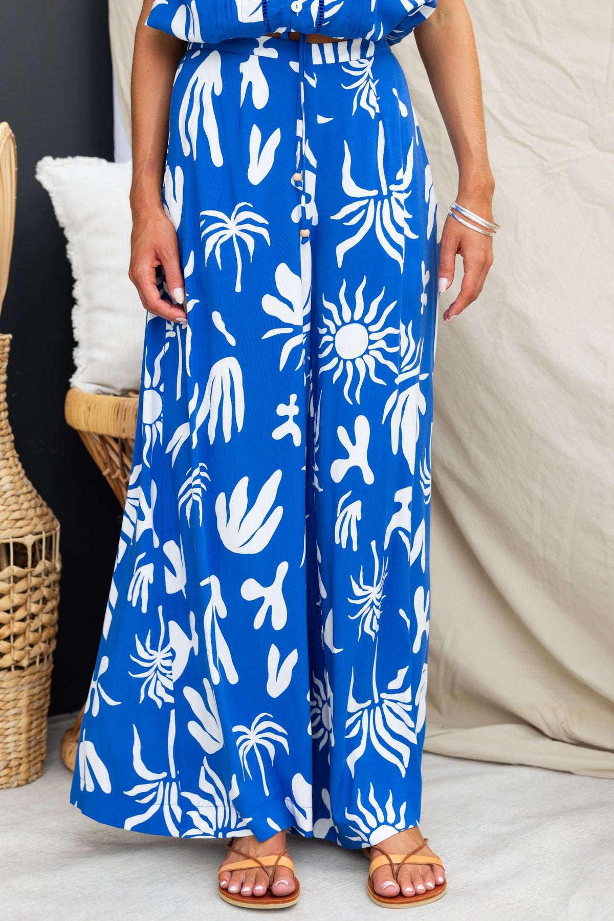 Ethan Pants featuring an abstract blue and white print, mid-high waist, elastic waistband, and pockets.