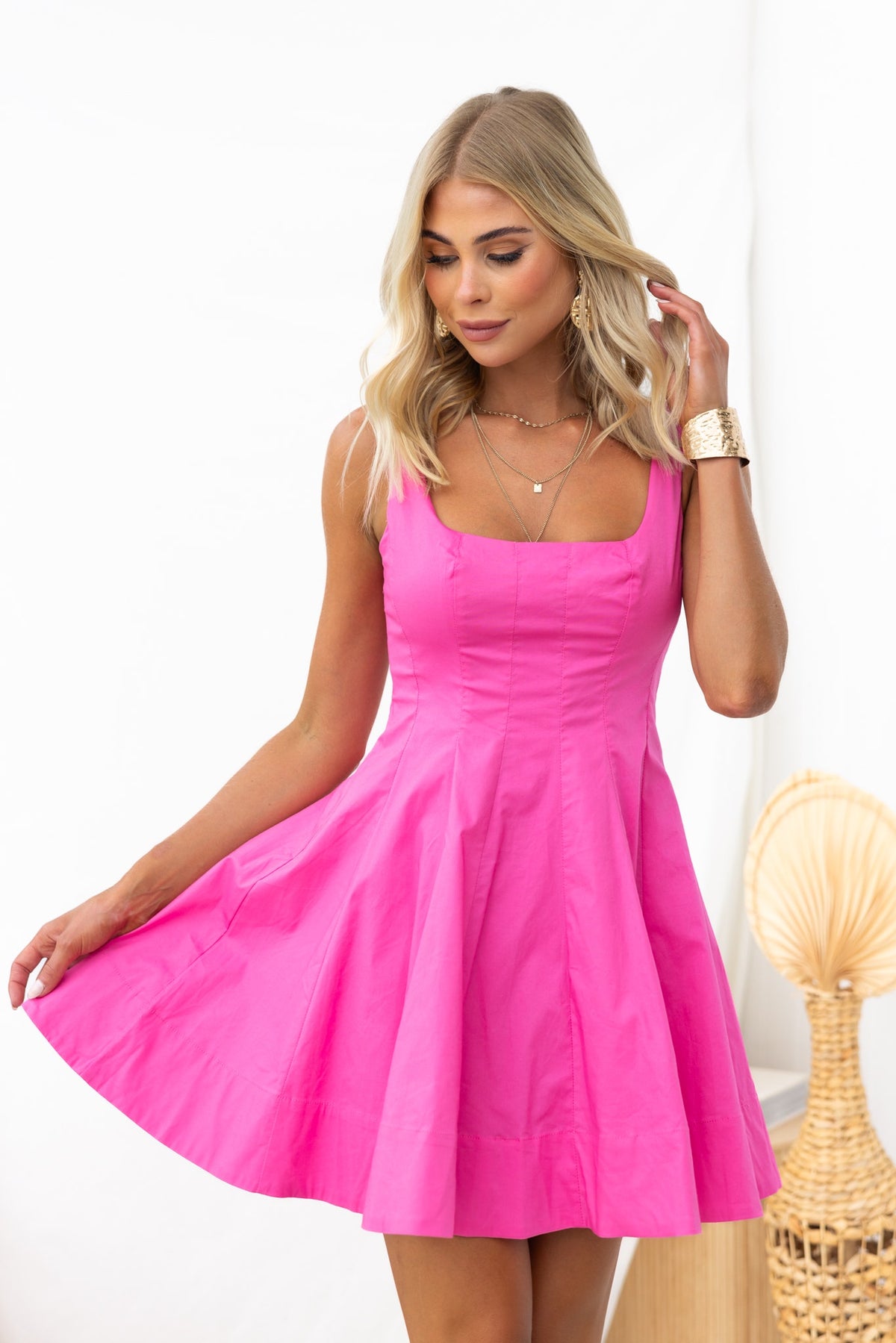 Bright pink Sincerity Dress with square neckline, perfect for summer outings, featuring a flared skirt and a flattering fit.