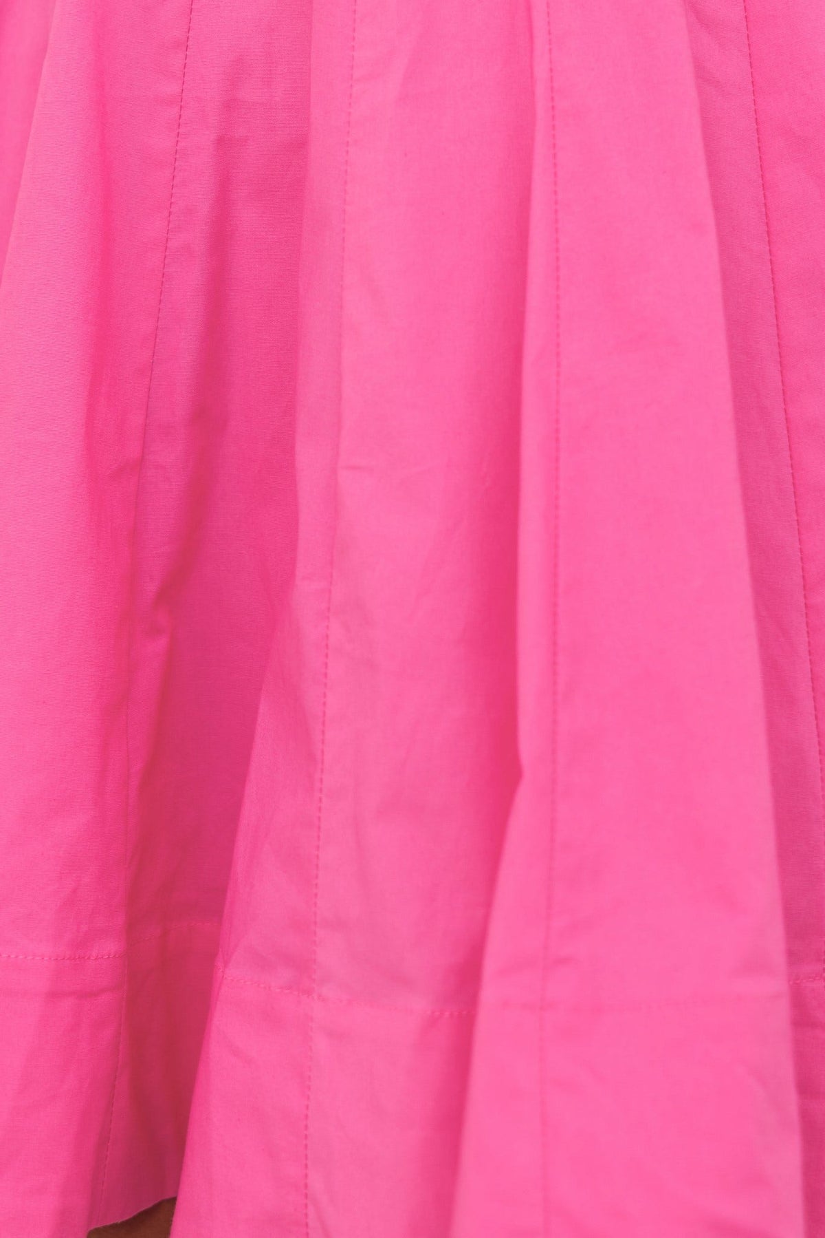 Bright pink fabric of the Sincerity Dress showcasing a textured pleated design.