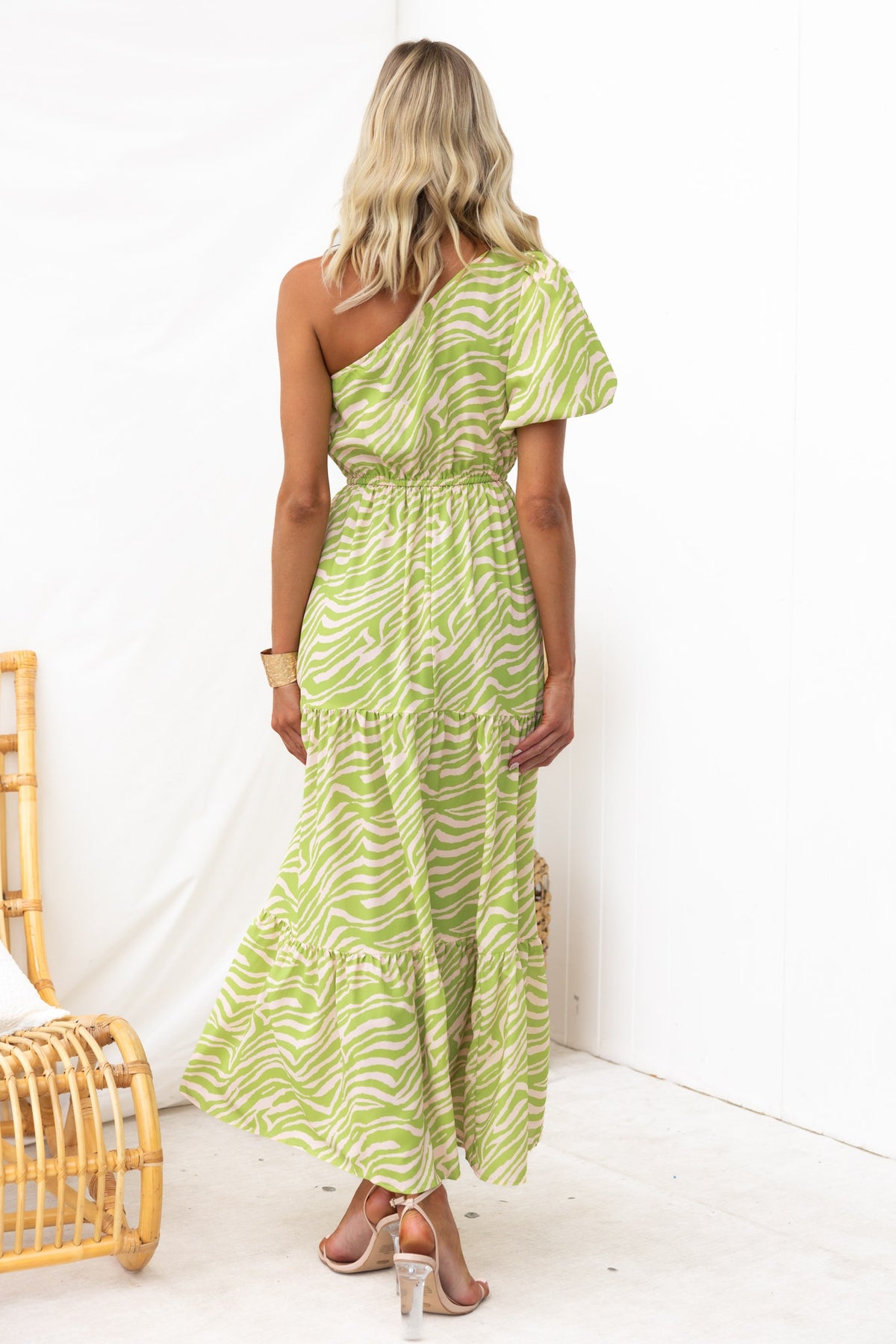 Back view of a Hardwick Maxi Dress featuring a one-shoulder design and animal print in green tones.