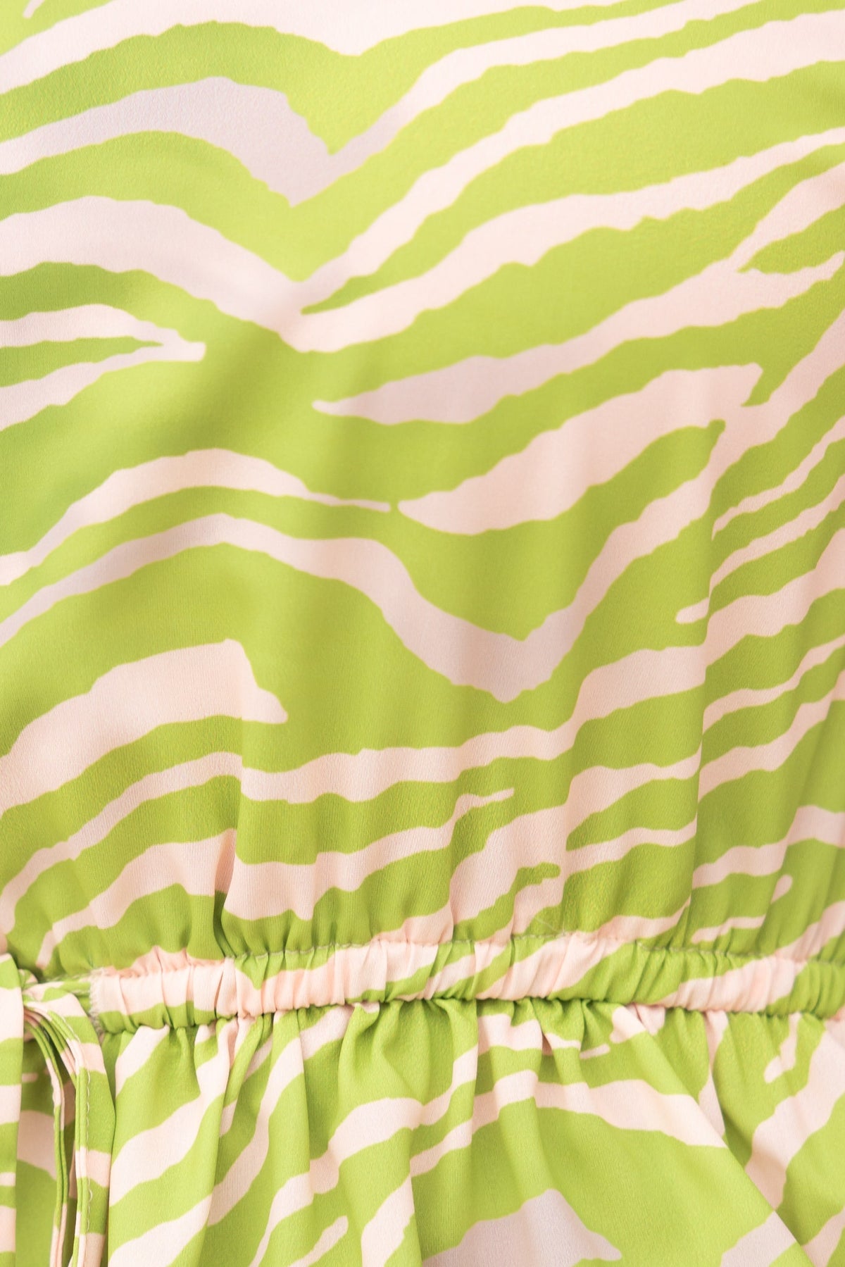 Close-up of the Hardwick Maxi Dress showcasing vibrant green and pink animal print fabric with gathered drawstring waist.