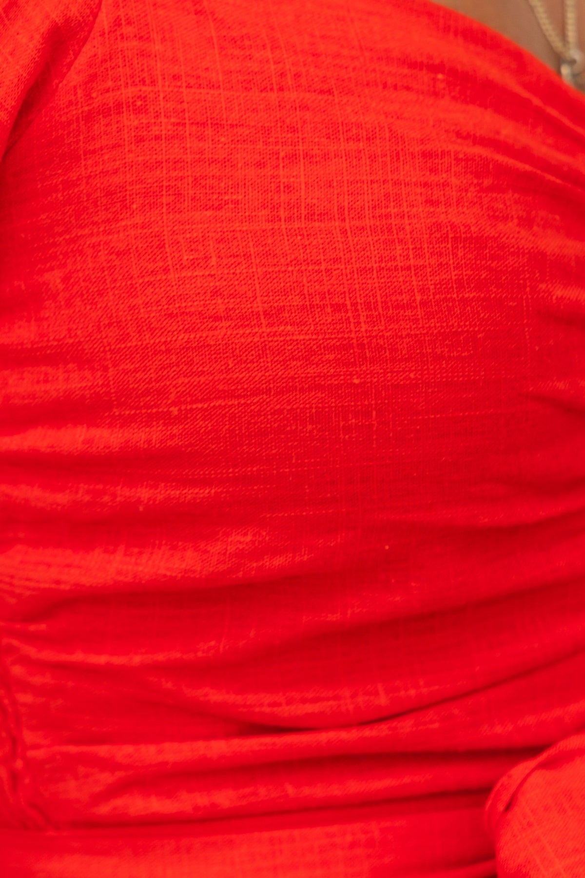 Close-up of the red Federica Dress fabric, highlighting its textured linen look and feel.