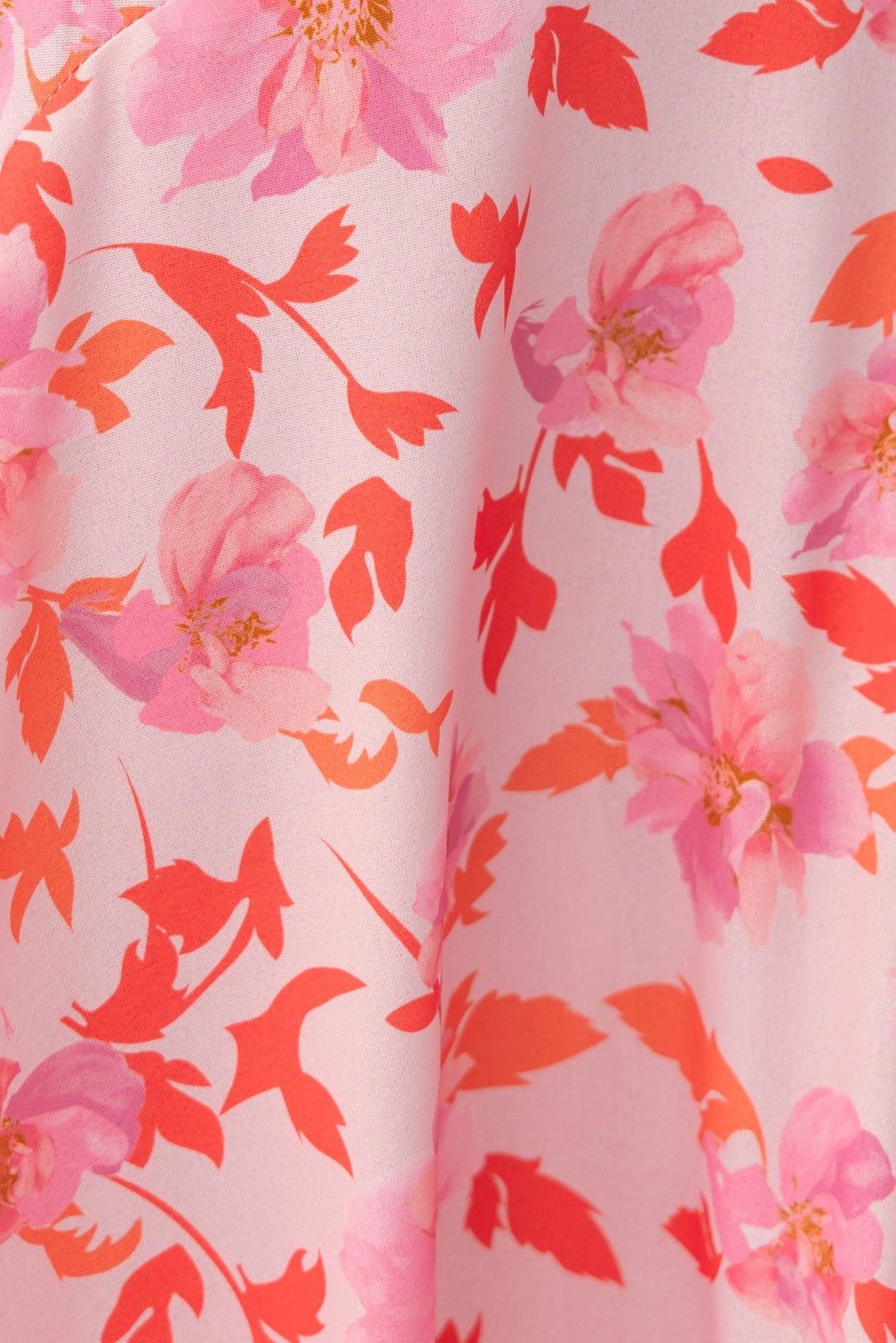 Close-up of floral print on fabric featuring pink and coral flowers, perfect for a Cupid Midi Dress.
