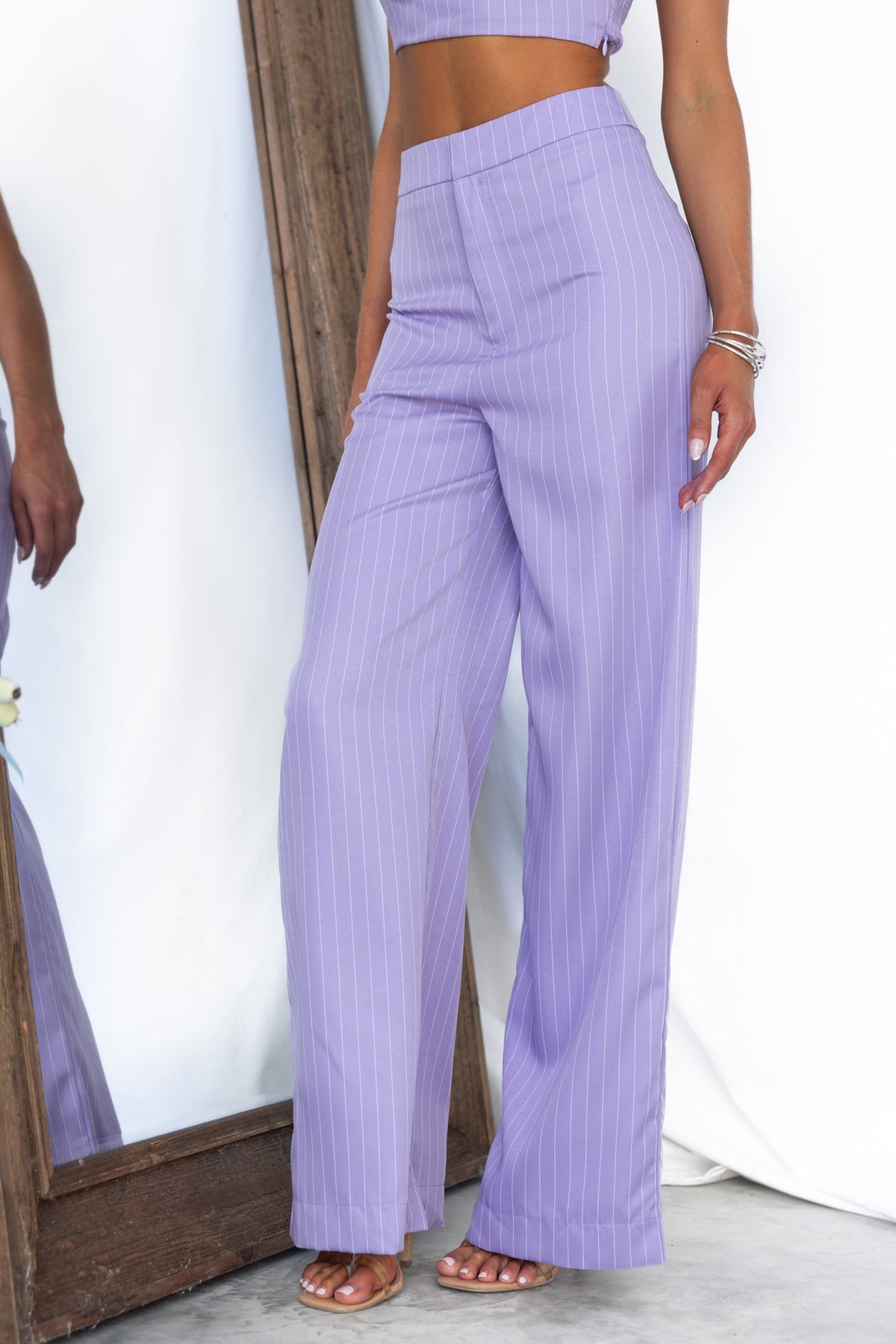 Silvia Pants in lavender with vertical stripes, mid-high waist fit, showcasing a stylish and standard fit for casual wear.