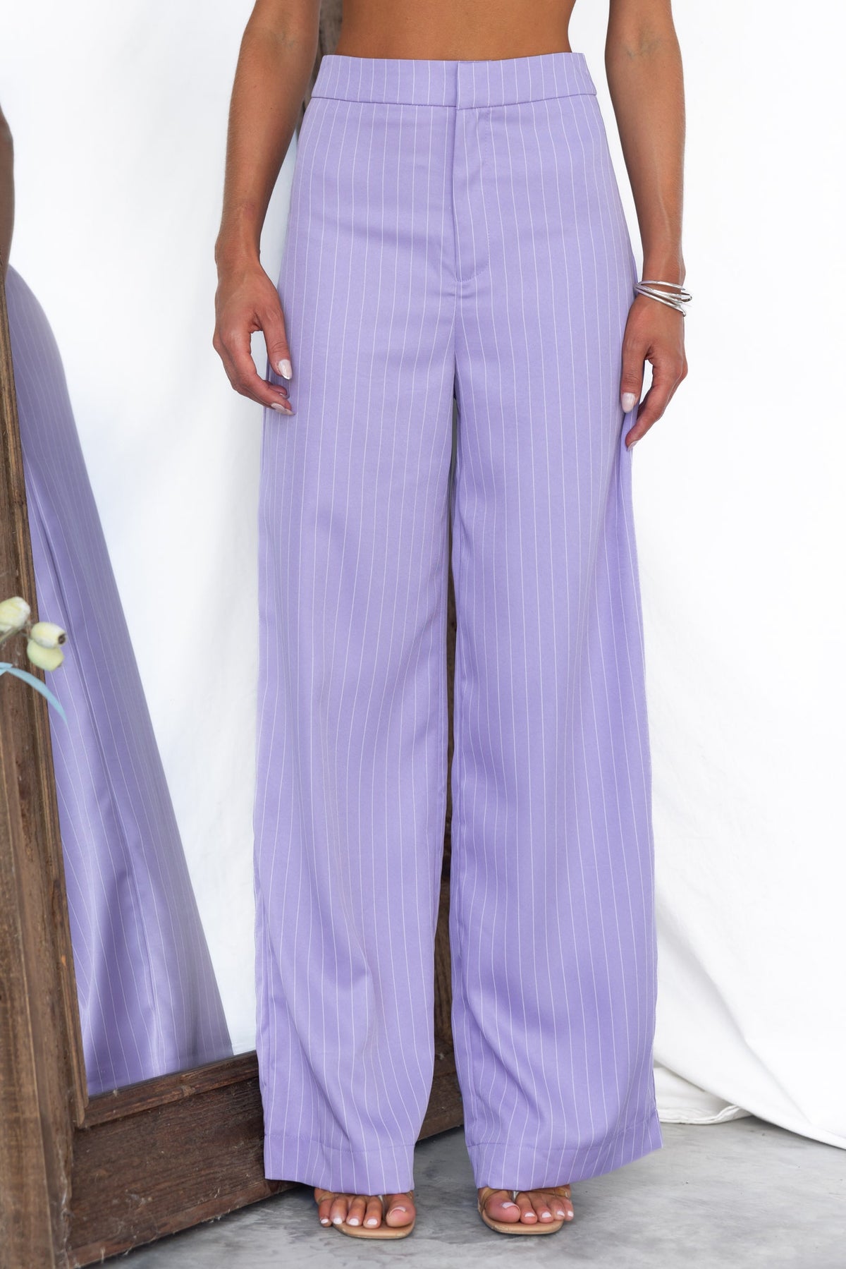 Silvia Pants in soft lavender with vertical stripes, featuring a mid-high waist fit and stylish wide-leg design.