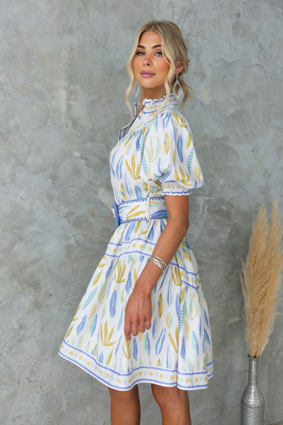 Kalmia Dress with floral print, high neckline, button-up front, and removable belt, model size 6/XS.