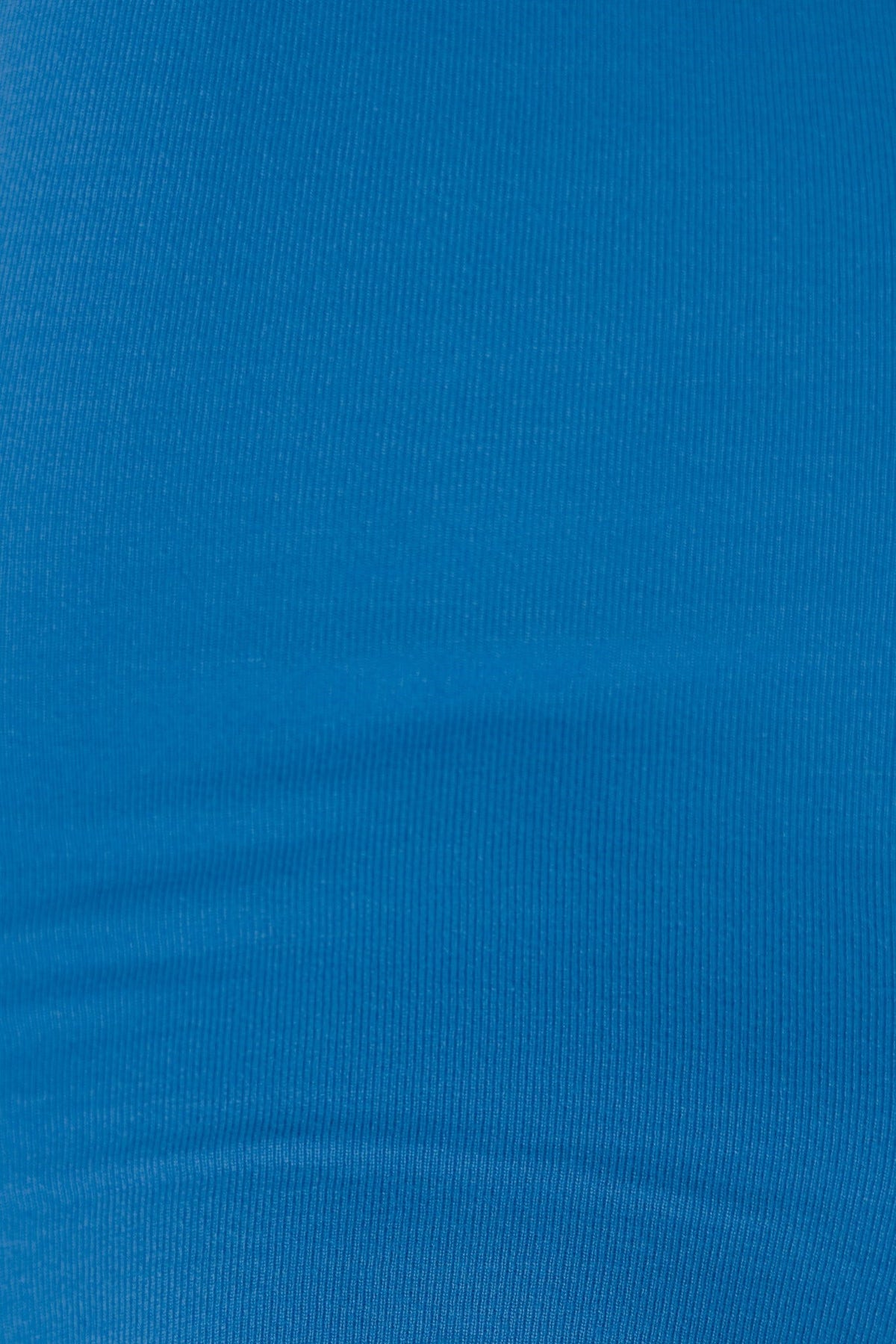 Close-up of smooth ribbed knit fabric in vibrant blue, showcasing its stretch and texture ideal for garments like dresses.
