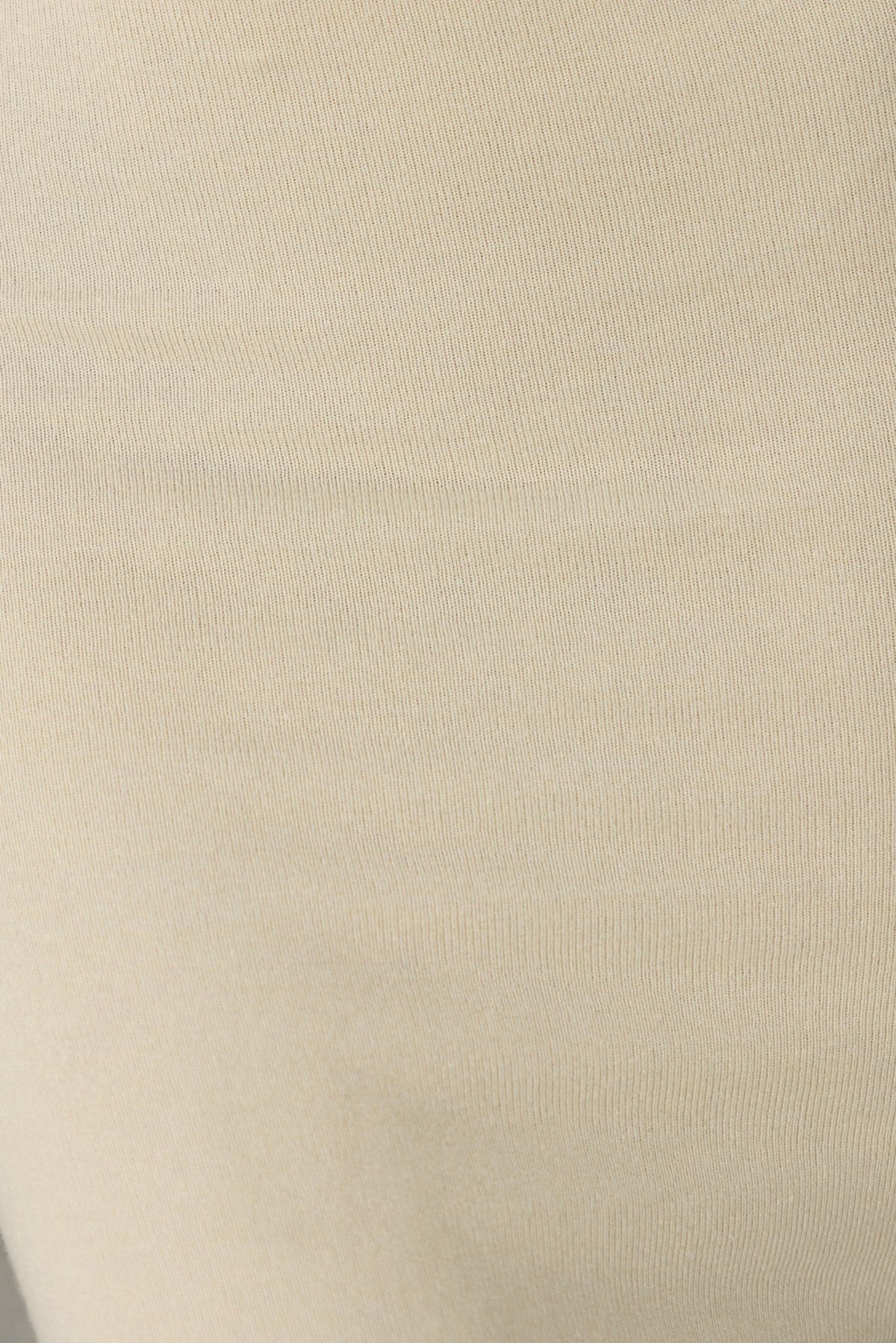 Close-up of the ribbed knit fabric of the Adelaide Midi Dress, showcasing its stretchy and comfortable texture.