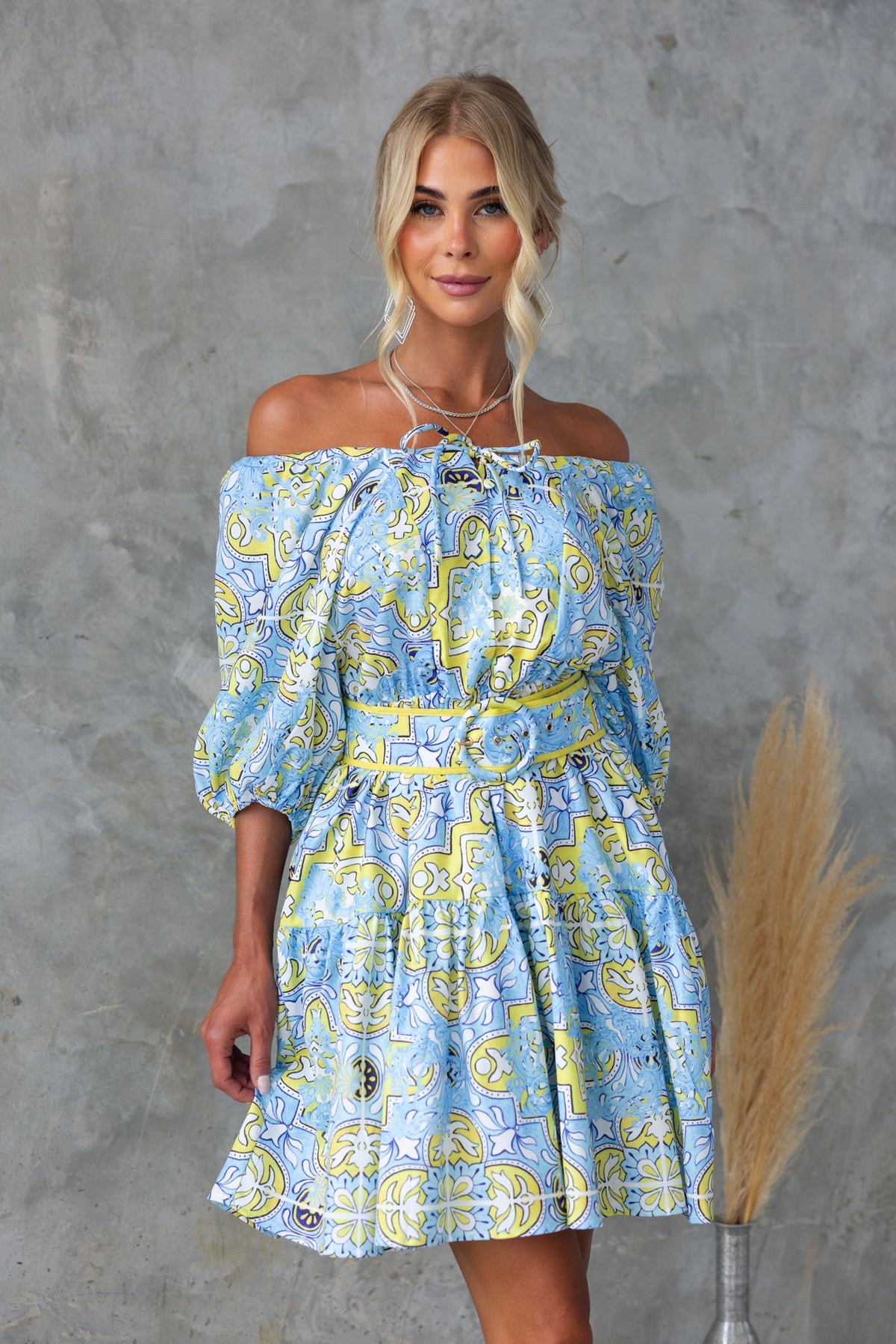 Stelle Dress featuring abstract print, adjustable tie neckline, elastic sleeves, and removable belt.
