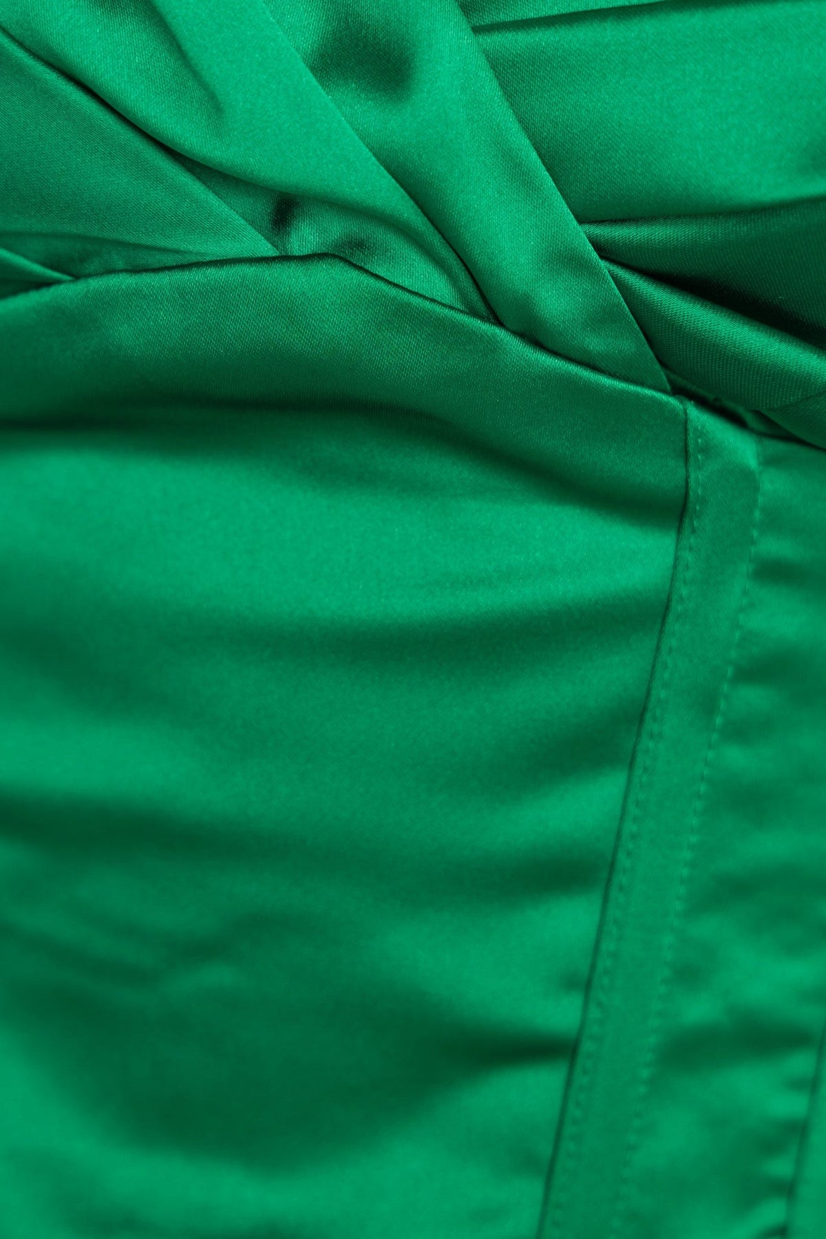 Close-up of green satin fabric showcasing the elegant draping of the Zoya Top with corset styling.