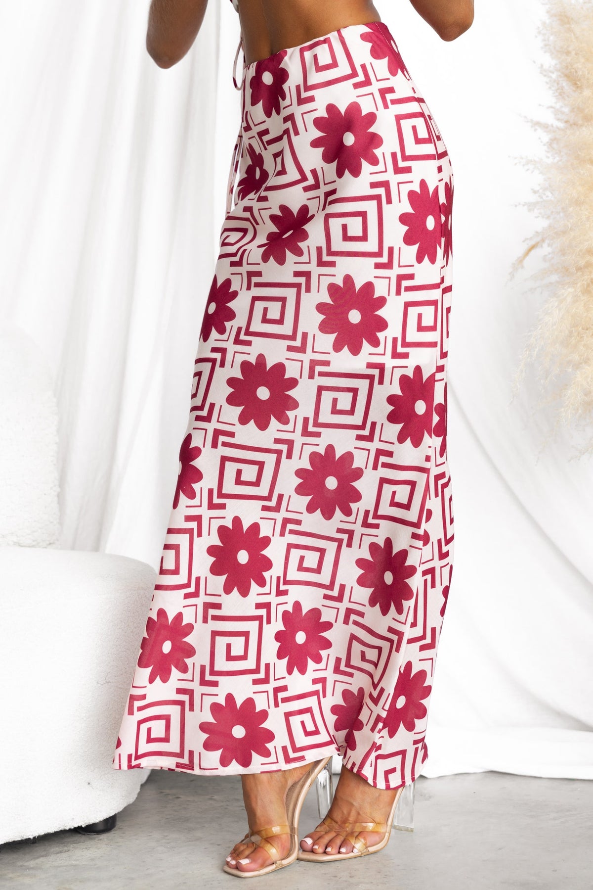 Model wearing Solani Maxi Skirt featuring floral pattern, mid-high waist, and light material, suitable for warm weather.