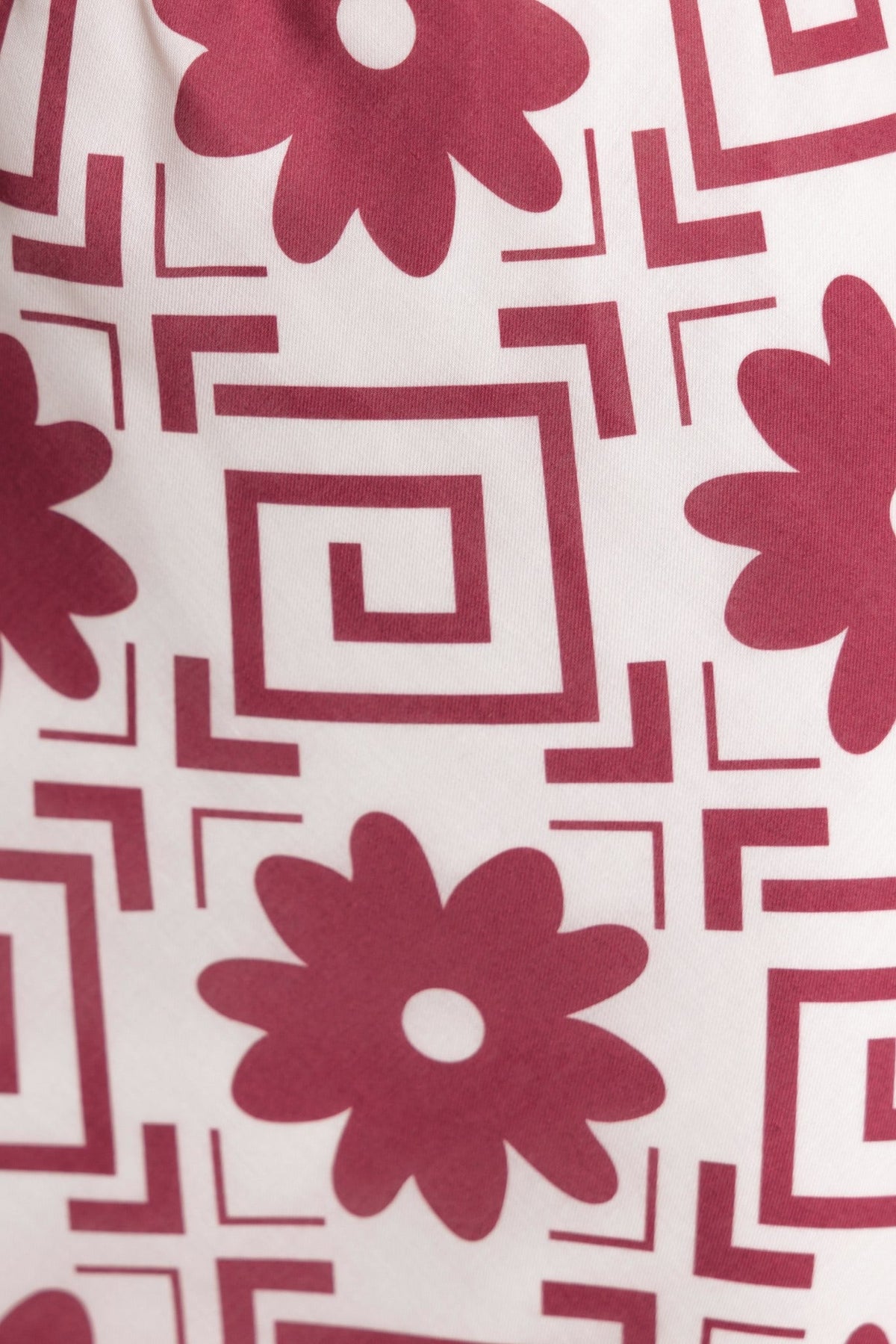 Close-up of a floral and geometric pattern in burgundy and cream, featured on the Solani Maxi Skirt.