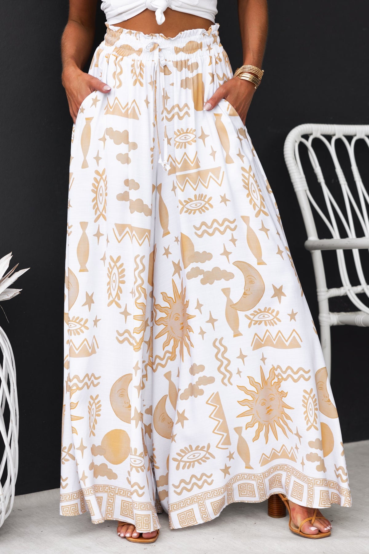 Amadi Pants featuring an abstract print, mid-high waist, wide legs, and elastic waistband with drawstring.